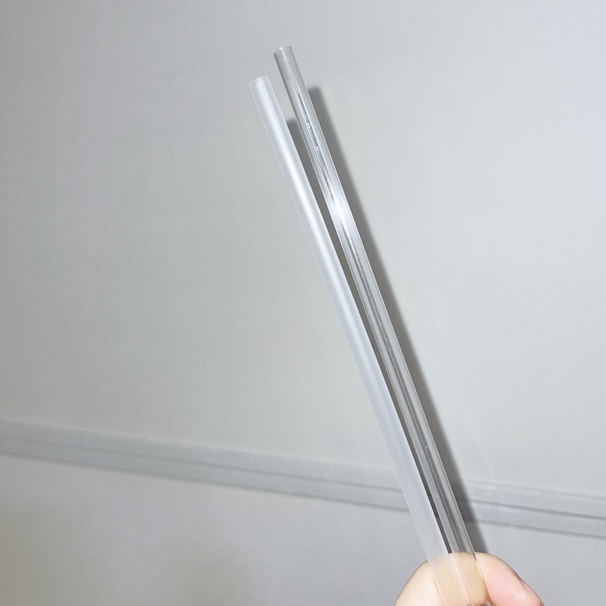 A set of 10.5” clear reusable straws displayed in a neat arrangement, showcasing their transparent design and eco-friendly packaging.