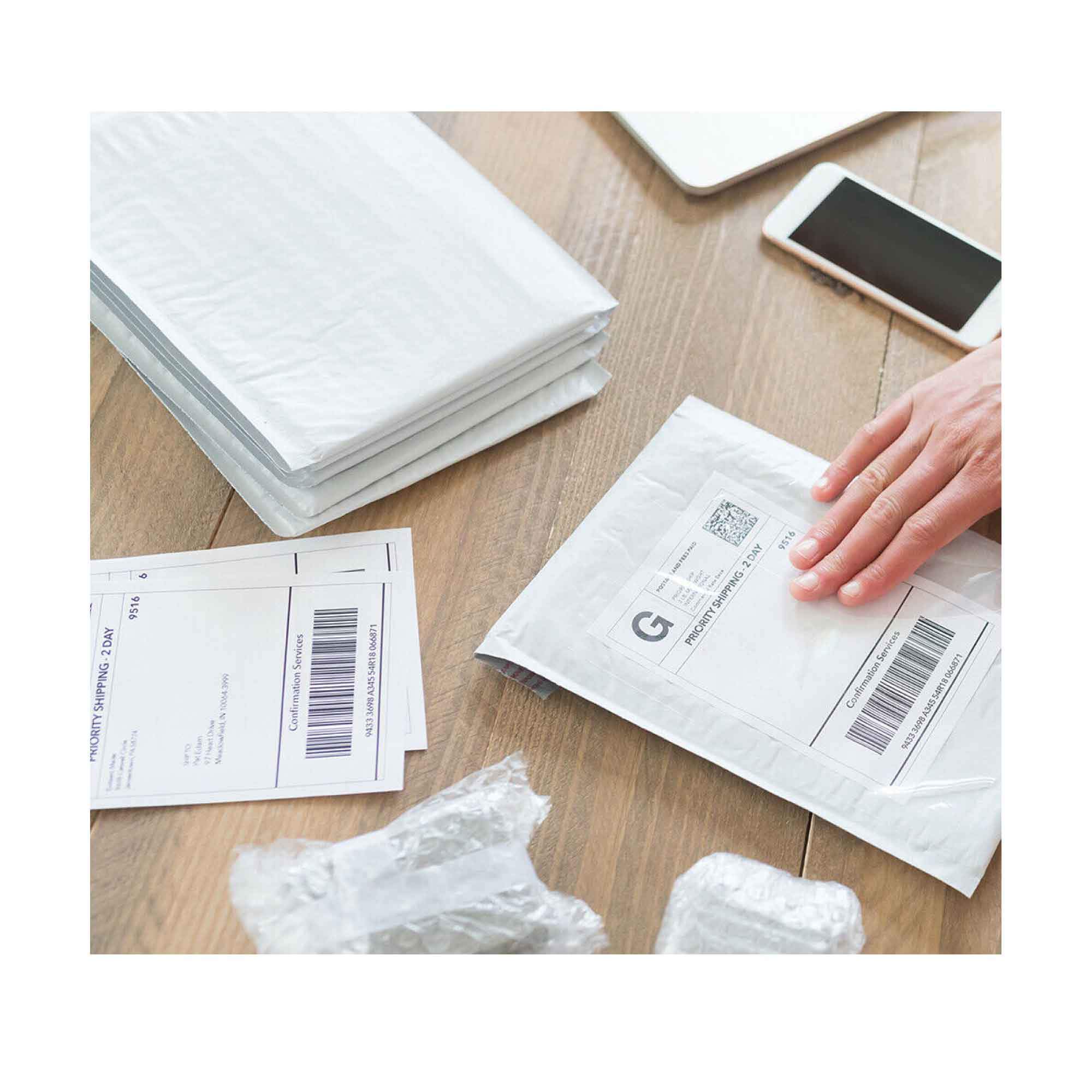 Person packing and labeling envelopes.