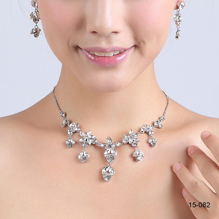 Elegant silver plated bridal necklace with matching rhinestone earrings, showcasing intricate design and sparkling details.