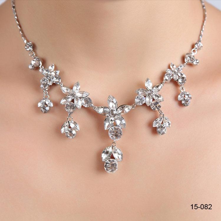 Elegant silver plated bridal necklace with matching rhinestone earrings, showcasing intricate design and sparkling details.