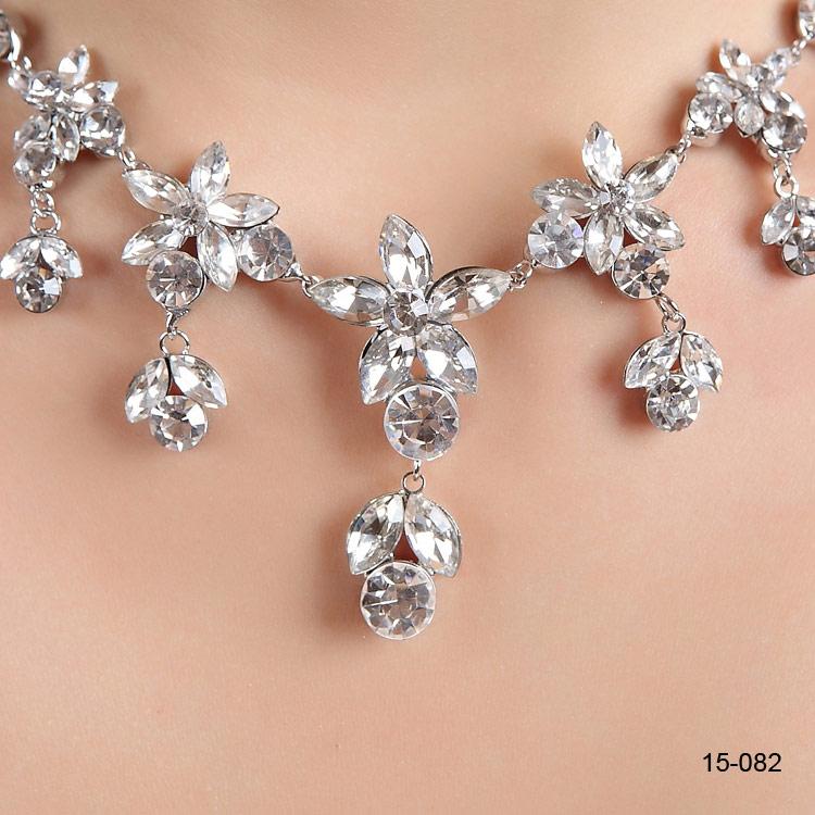 Elegant silver plated bridal necklace with matching rhinestone earrings, showcasing intricate design and sparkling details.