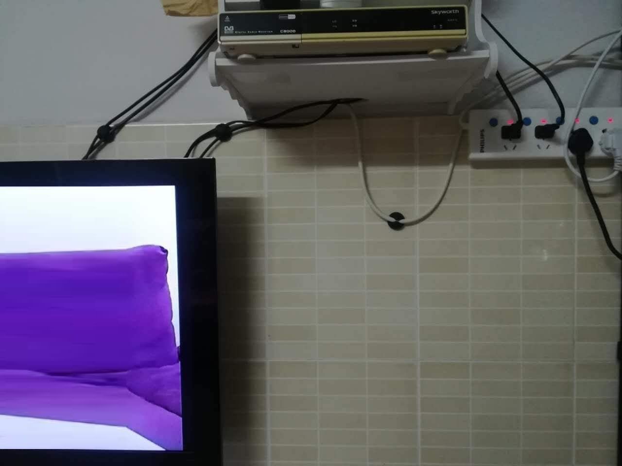 A pack of 16 black cord organizers with various sizes, designed for cable management in home and office settings.