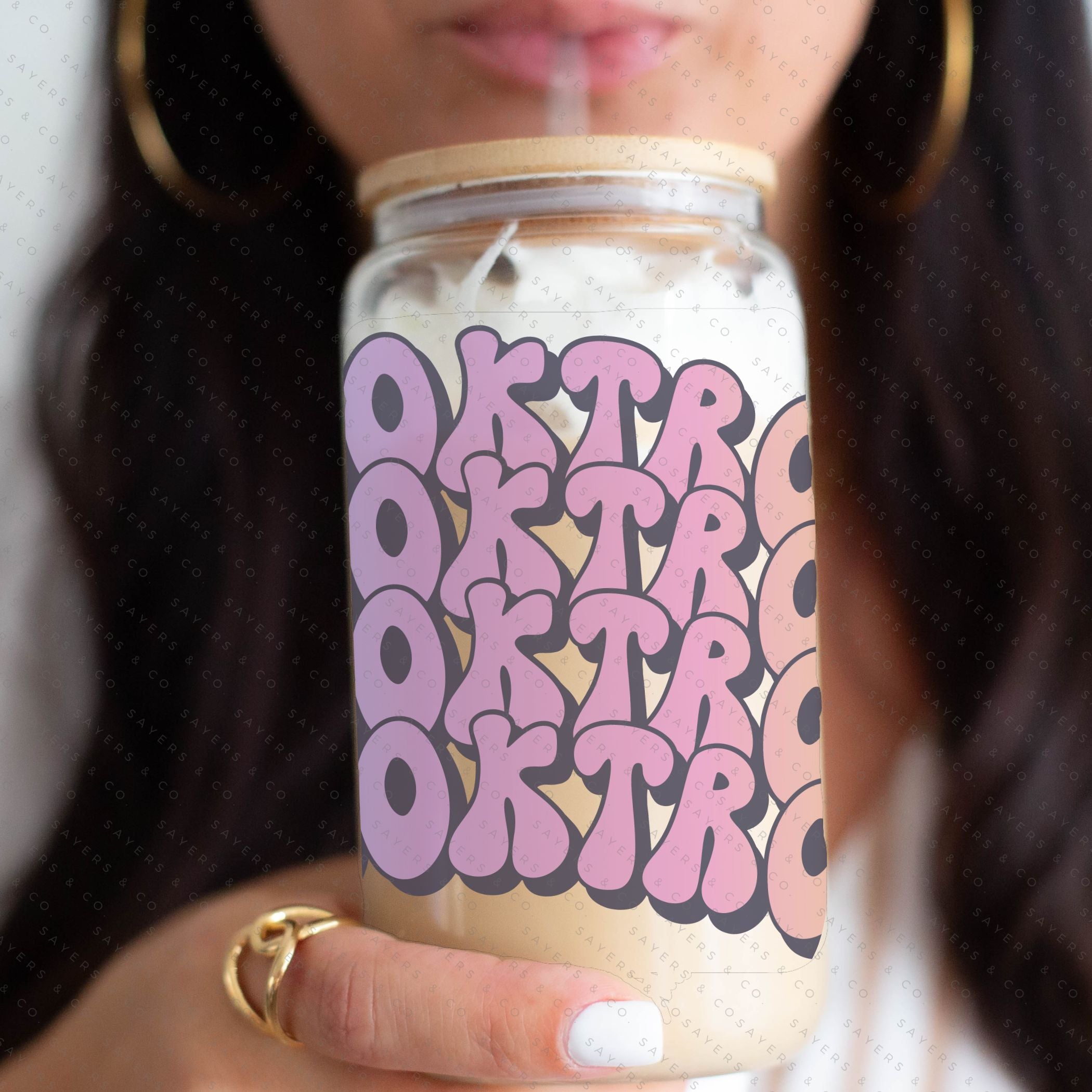 16oz Booktrovert Glass Cup featuring a bamboo lid and clear straw, perfect for iced coffee and other beverages.