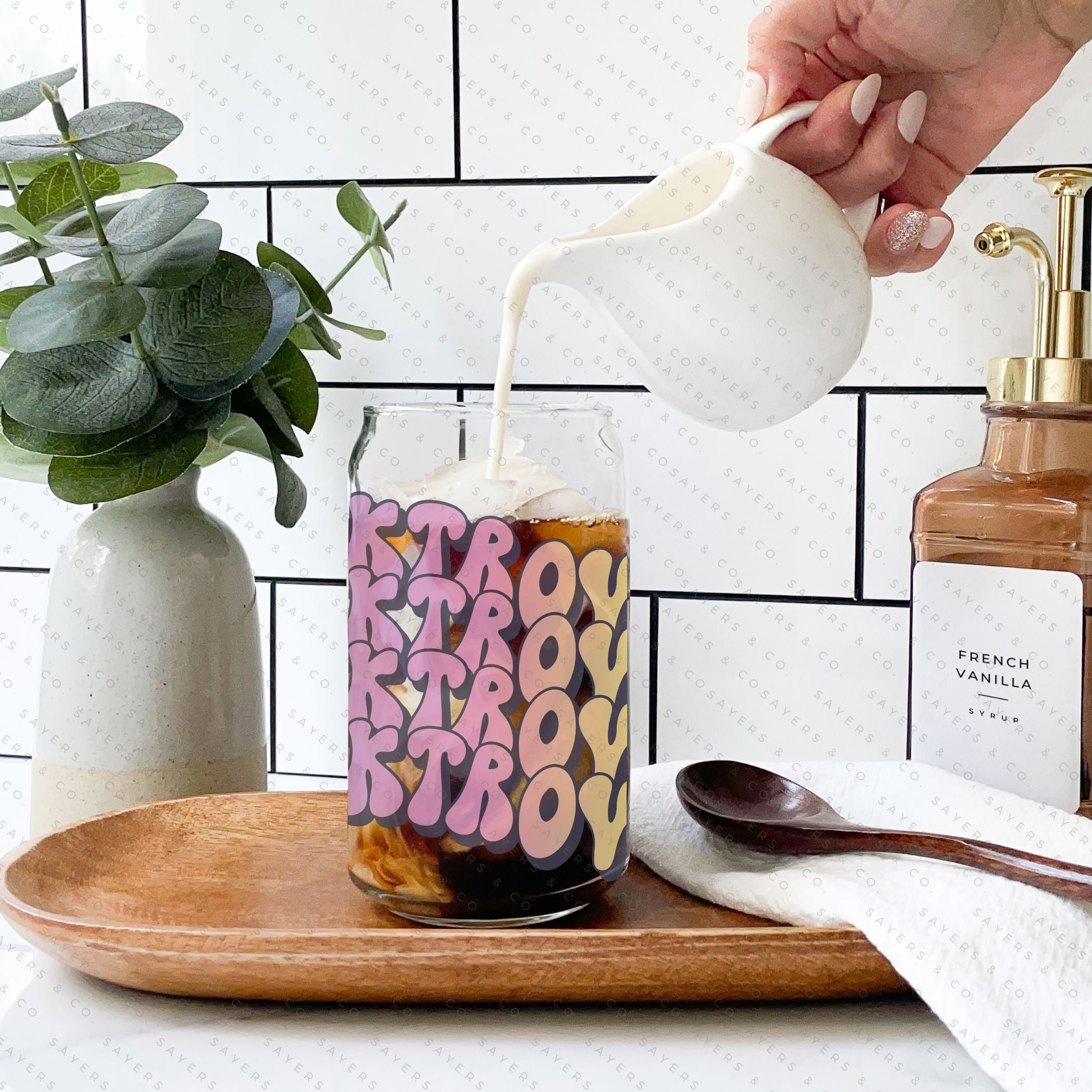 16oz Booktrovert Glass Cup featuring a bamboo lid and clear straw, perfect for iced coffee and other beverages.