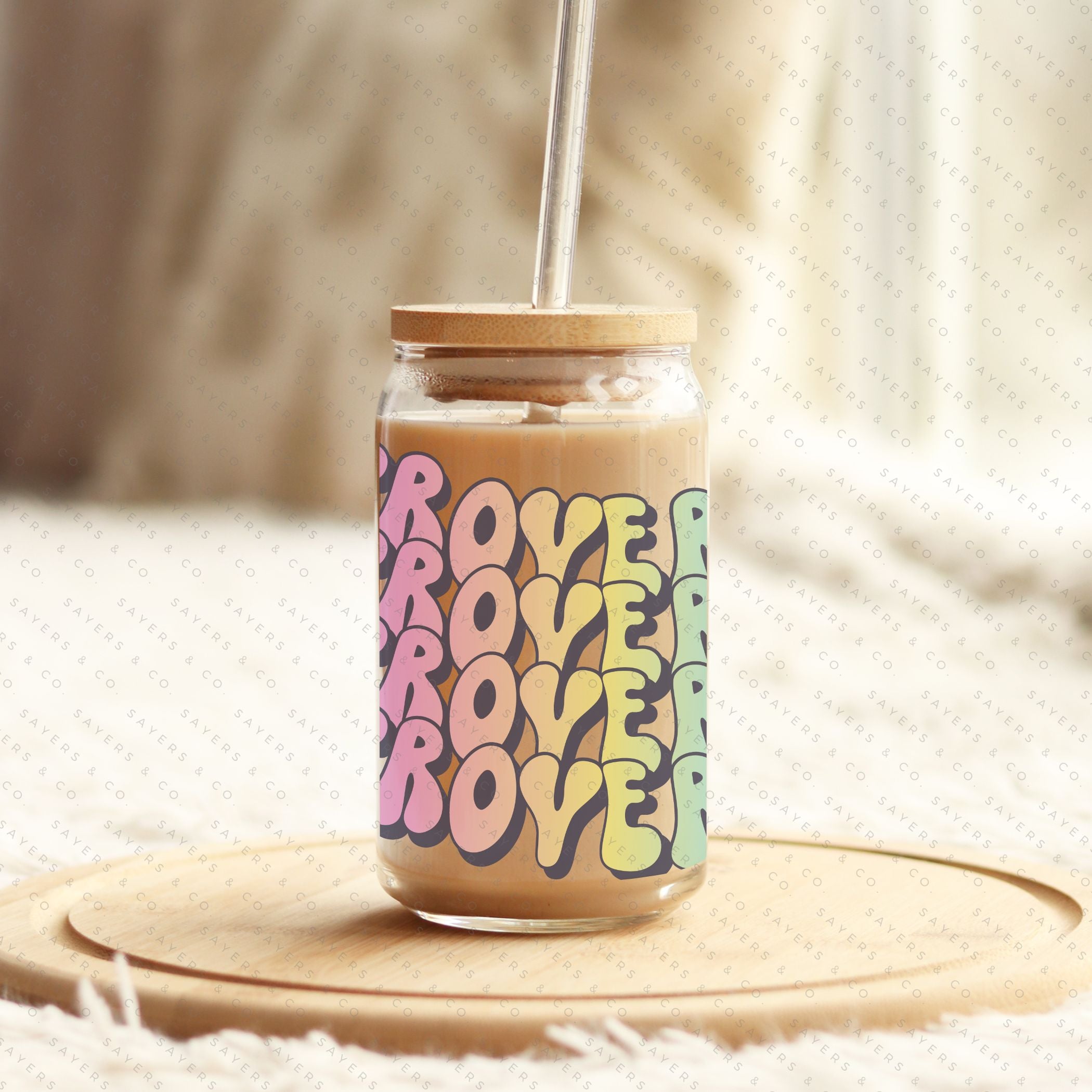 16oz Booktrovert Glass Cup featuring a bamboo lid and clear straw, perfect for iced coffee and other beverages.