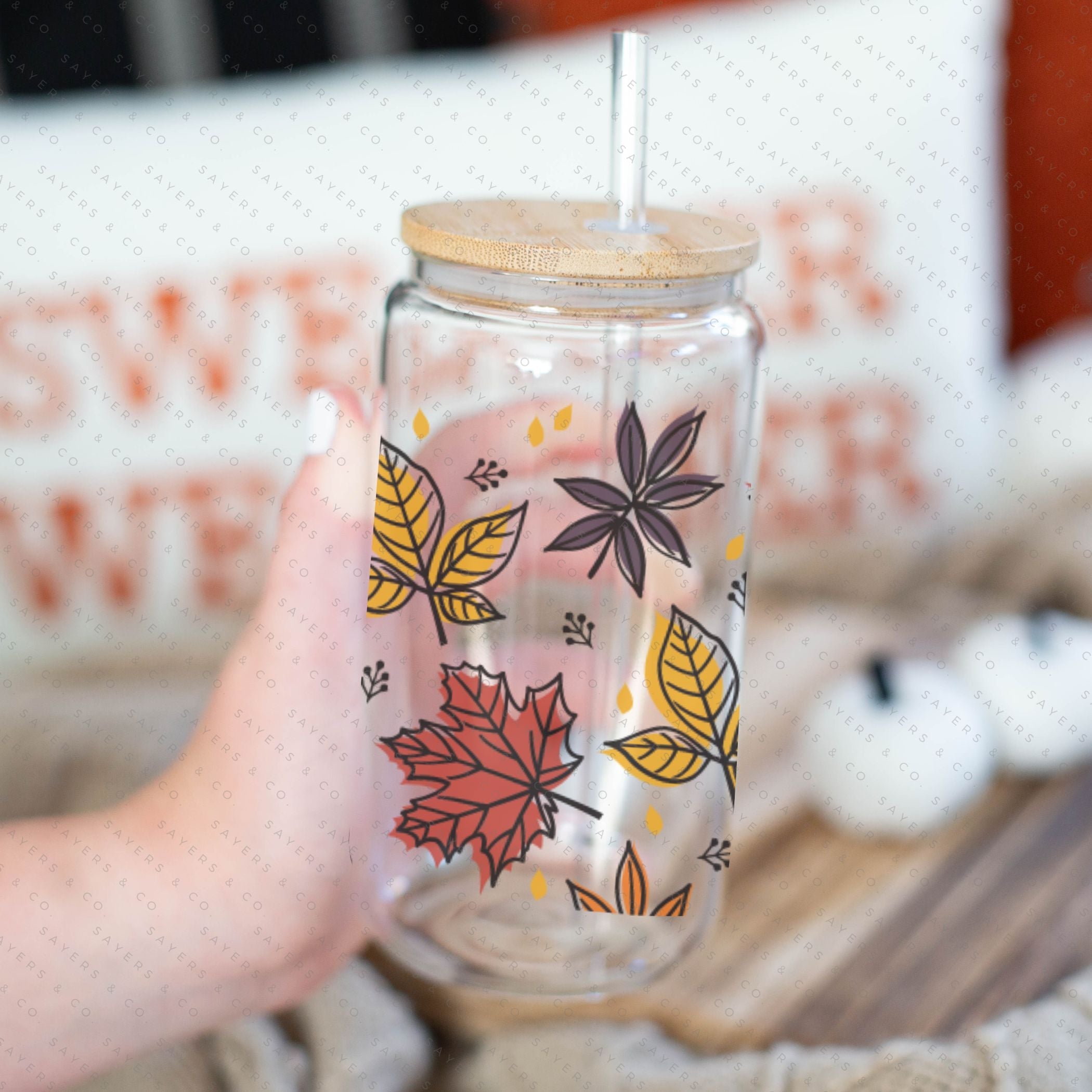 16oz Fall Leaves Glass Cup featuring a bamboo lid and straw, showcasing a beautiful autumn leaves design, perfect for seasonal beverages.