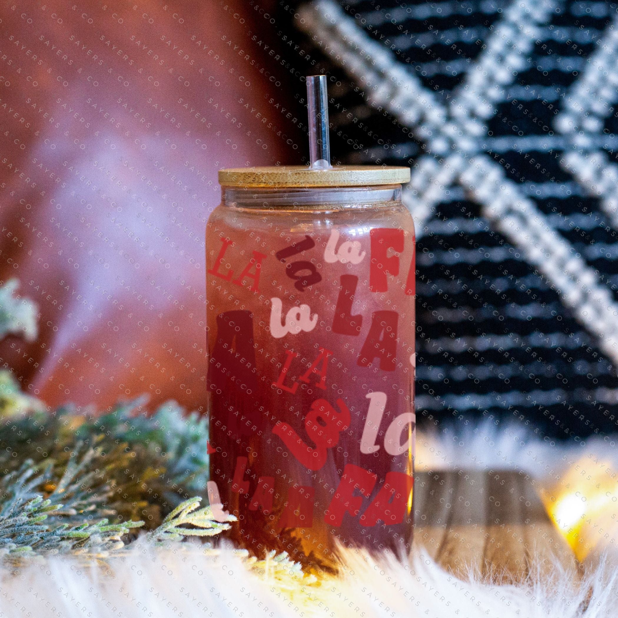 16oz Falala Christmas Lyrics Glass Cup featuring a bamboo lid and straw, perfect for festive drinks.