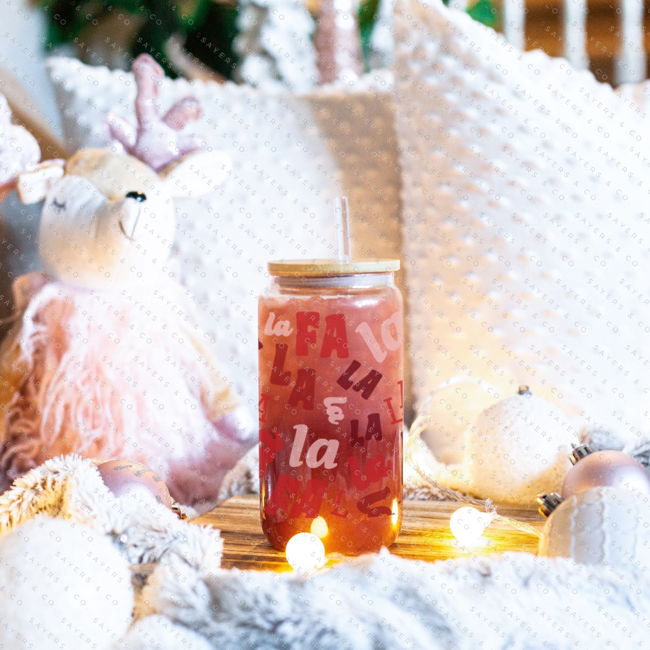 16oz Falala Christmas Lyrics Glass Cup featuring a bamboo lid and straw, perfect for festive drinks.