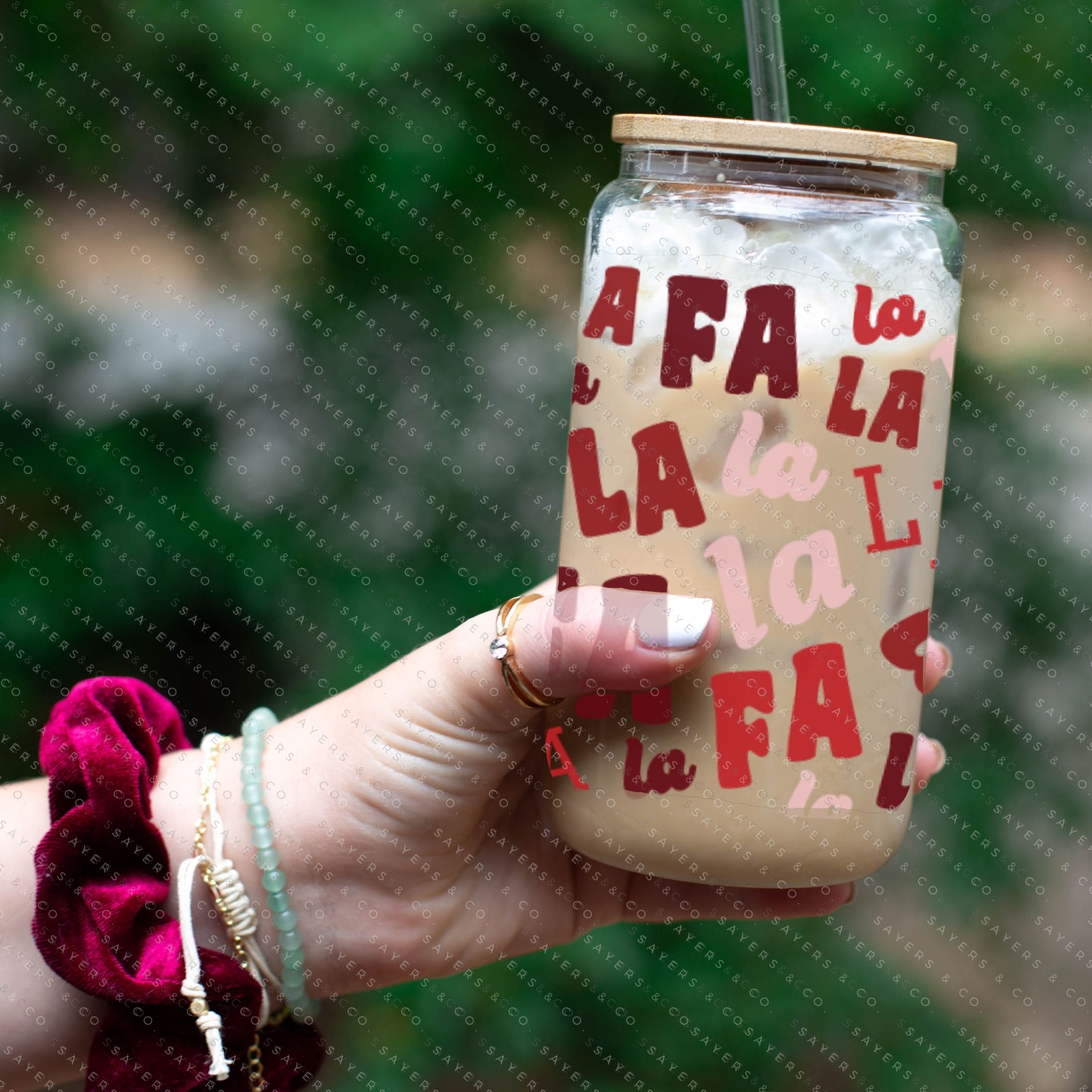 16oz Falala Christmas Lyrics Glass Cup featuring a bamboo lid and straw, perfect for festive drinks.
