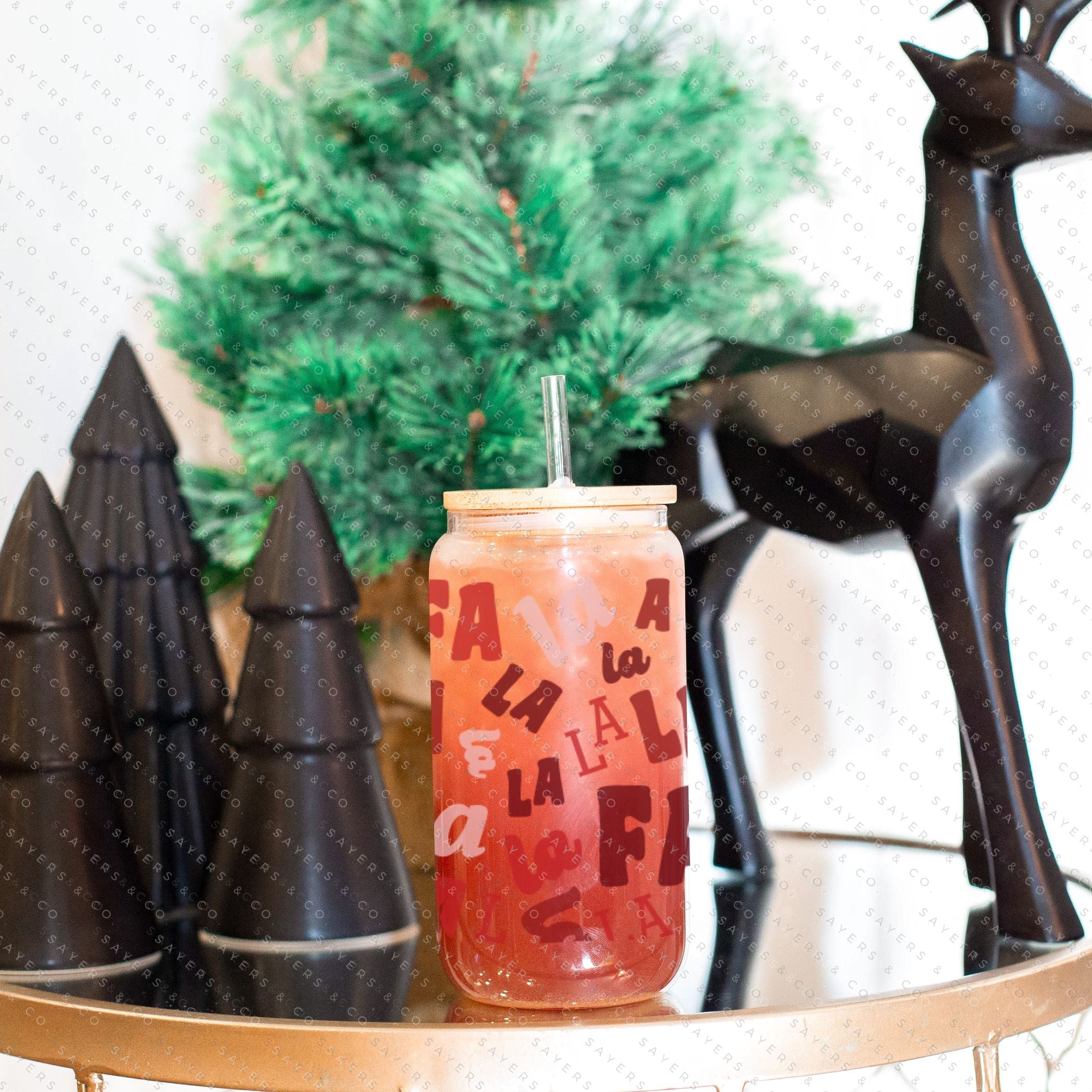 16oz Falala Christmas Lyrics Glass Cup featuring a bamboo lid and straw, perfect for festive drinks.