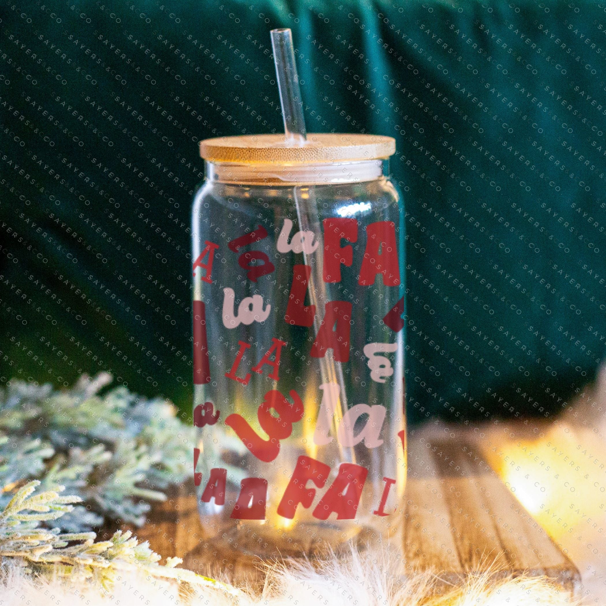 16oz Falala Christmas Lyrics Glass Cup featuring a bamboo lid and straw, perfect for festive drinks.