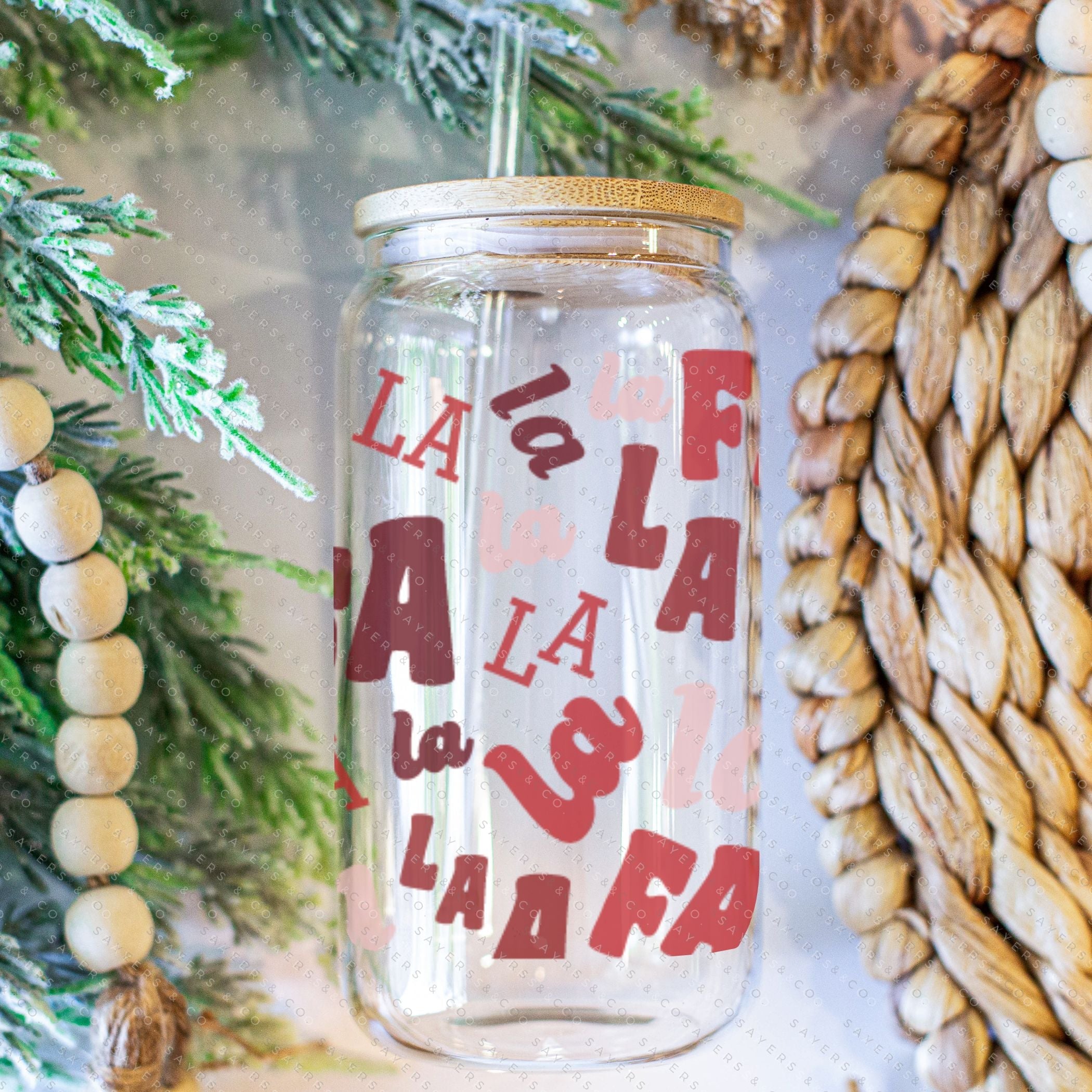 16oz Falala Christmas Lyrics Glass Cup featuring a bamboo lid and straw, perfect for festive drinks.