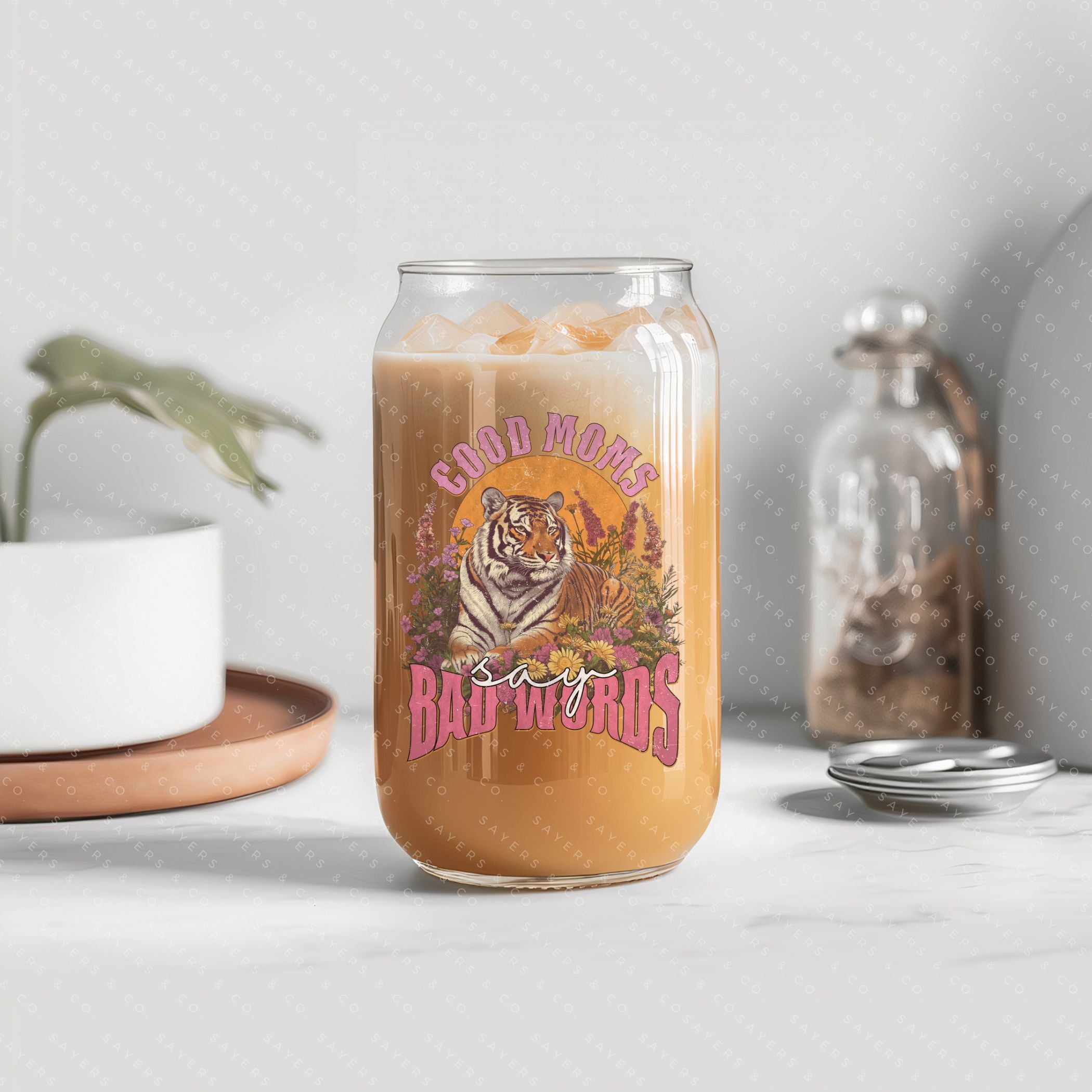 16oz Good Moms Say Bad Words Glass Cup with bamboo lid and straw, showcasing a humorous design perfect for moms and teachers.