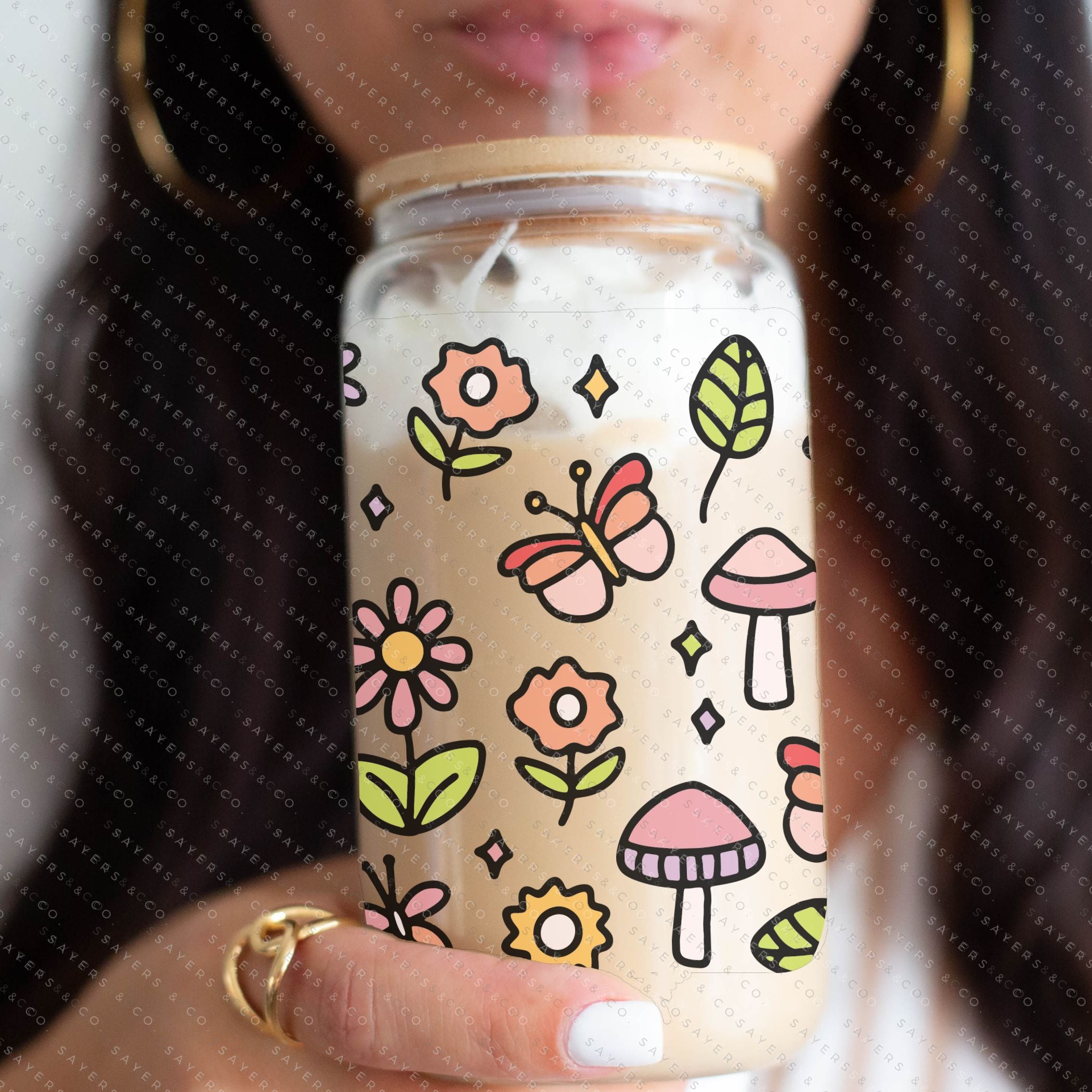 16oz Happy Fields Glass Cup with bamboo lid and straw, showcasing a vibrant design perfect for summer drinks.