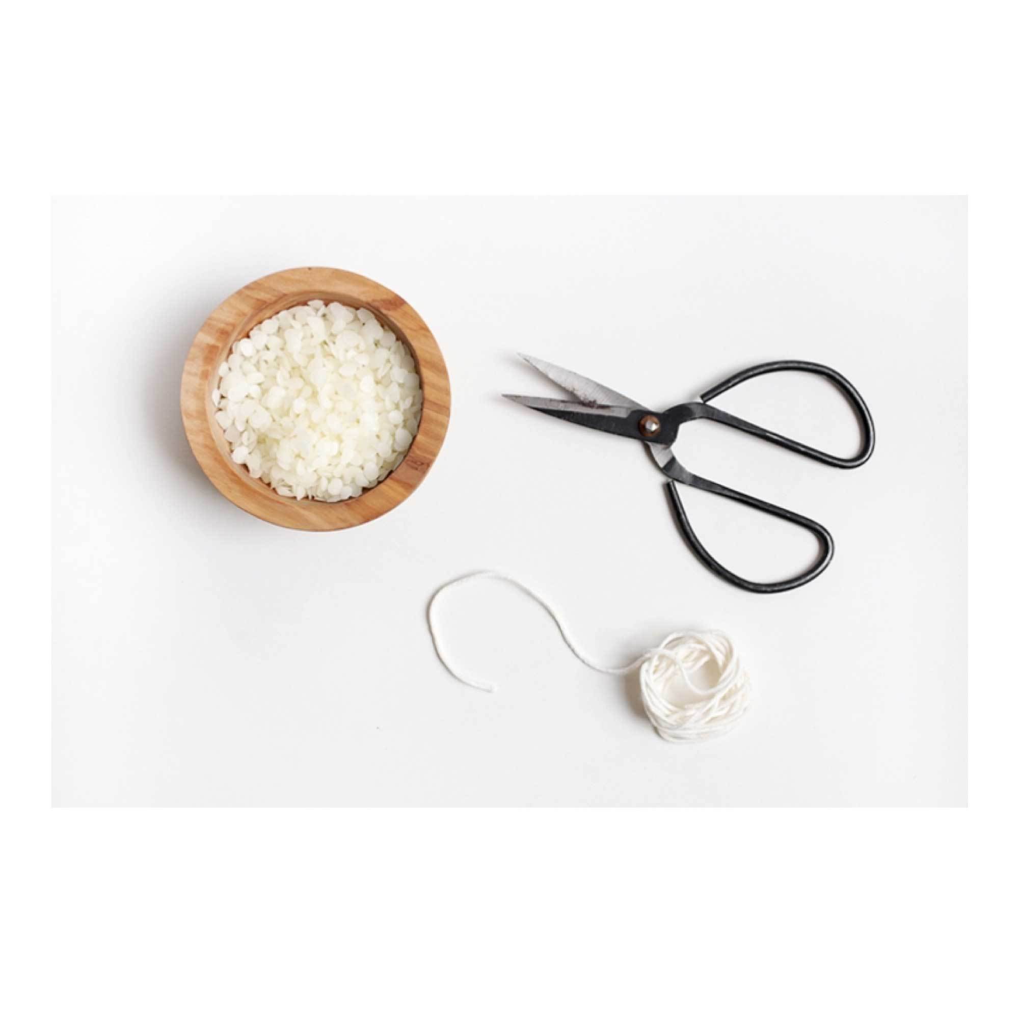 1kg bag of natural white beeswax pellets, pharmaceutical grade, suitable for candle making and cosmetics.