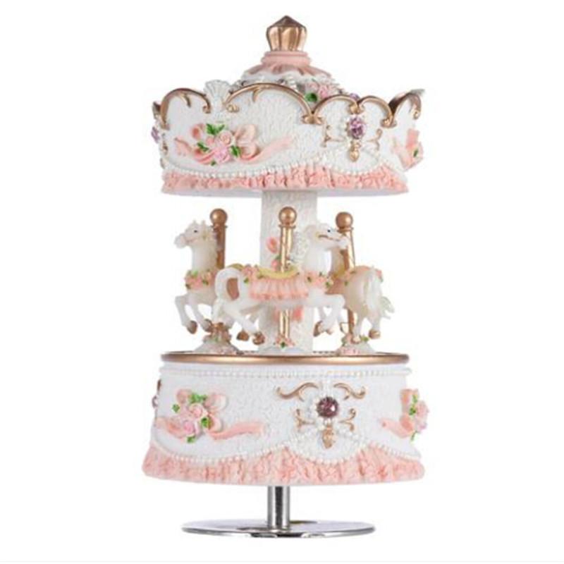 2018 Luxury Windup Carousel Music Box with three rotating horses and intricate carvings, featuring a pink color and a spring mechanism.