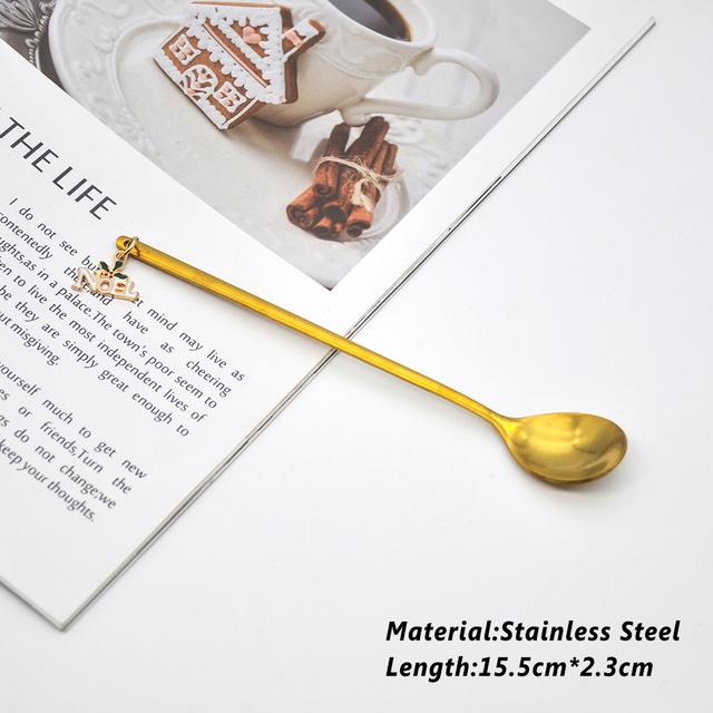 A beautifully designed Creative Metal Merry Christmas Spoon in gold with a Christmas pendant, perfect for holiday celebrations.