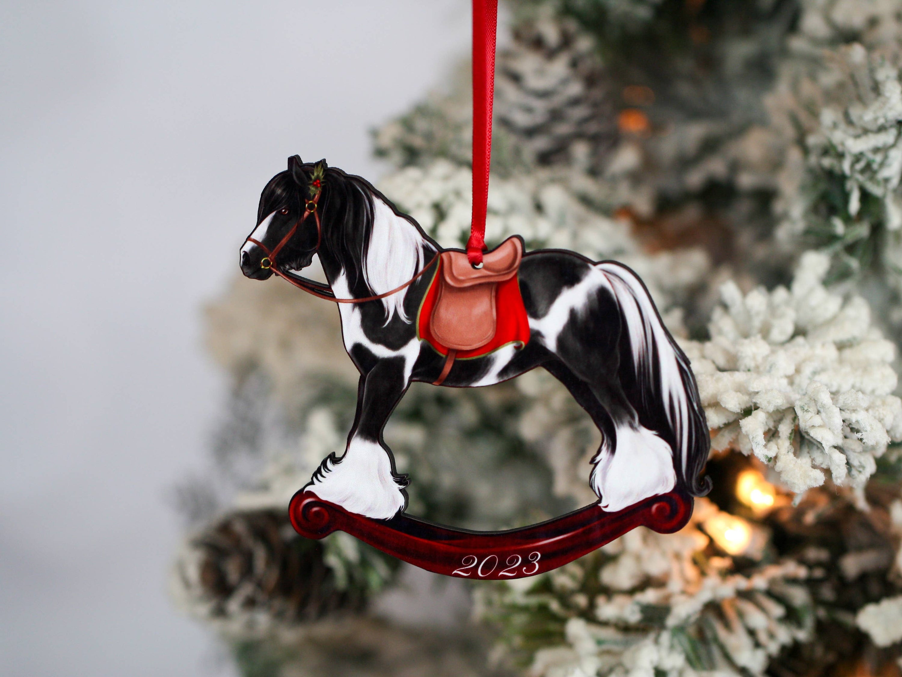 2023 Black Tobiano Gypsy Rocking Horse Christmas Ornament, handmade from composite wood with a glossy finish, featuring intricate laser-cut details.