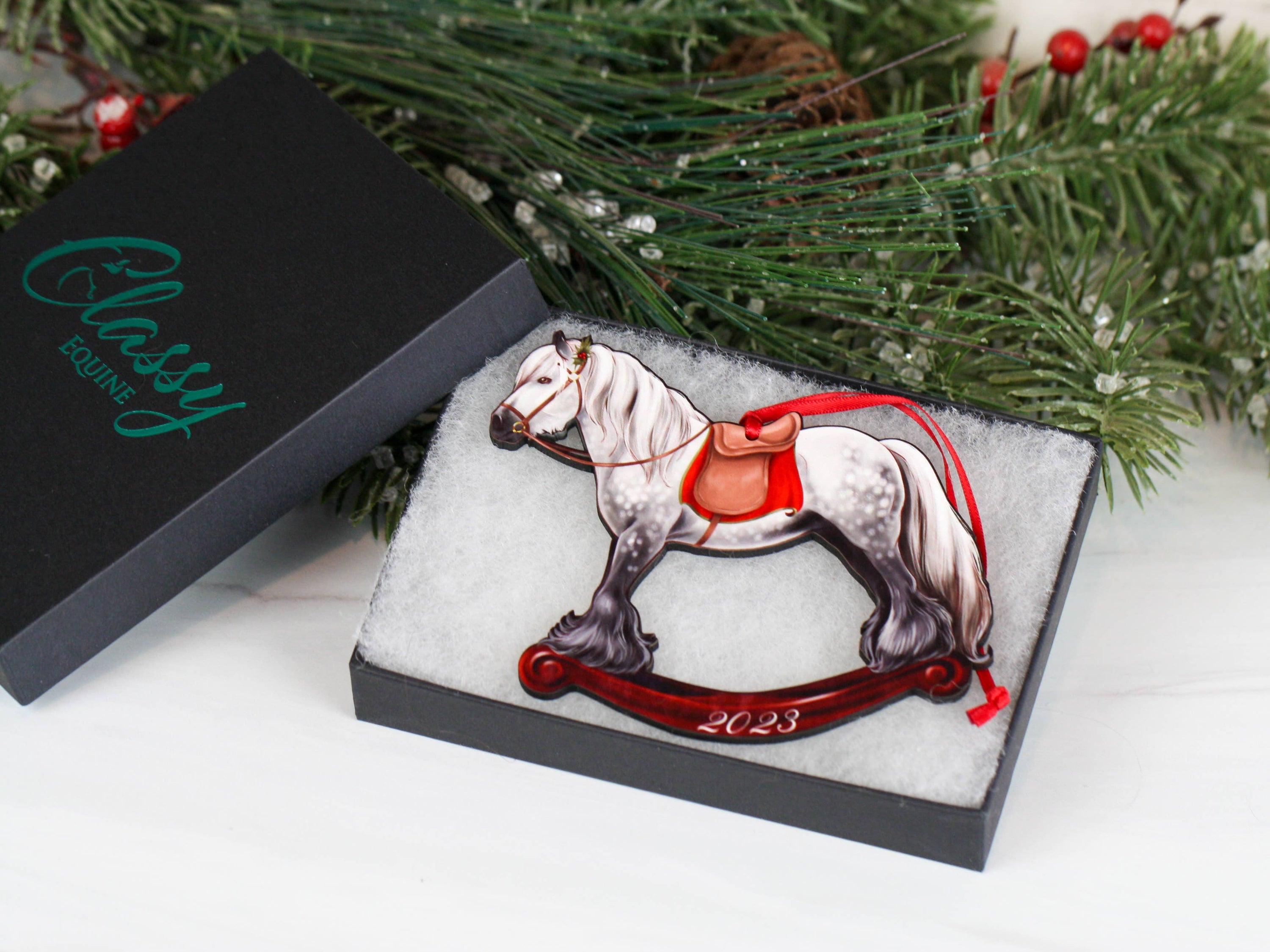 2023 Gray Gypsy Rocking Horse Christmas Ornament, handmade from composite wood with a glossy finish, featuring red and black ribbons.