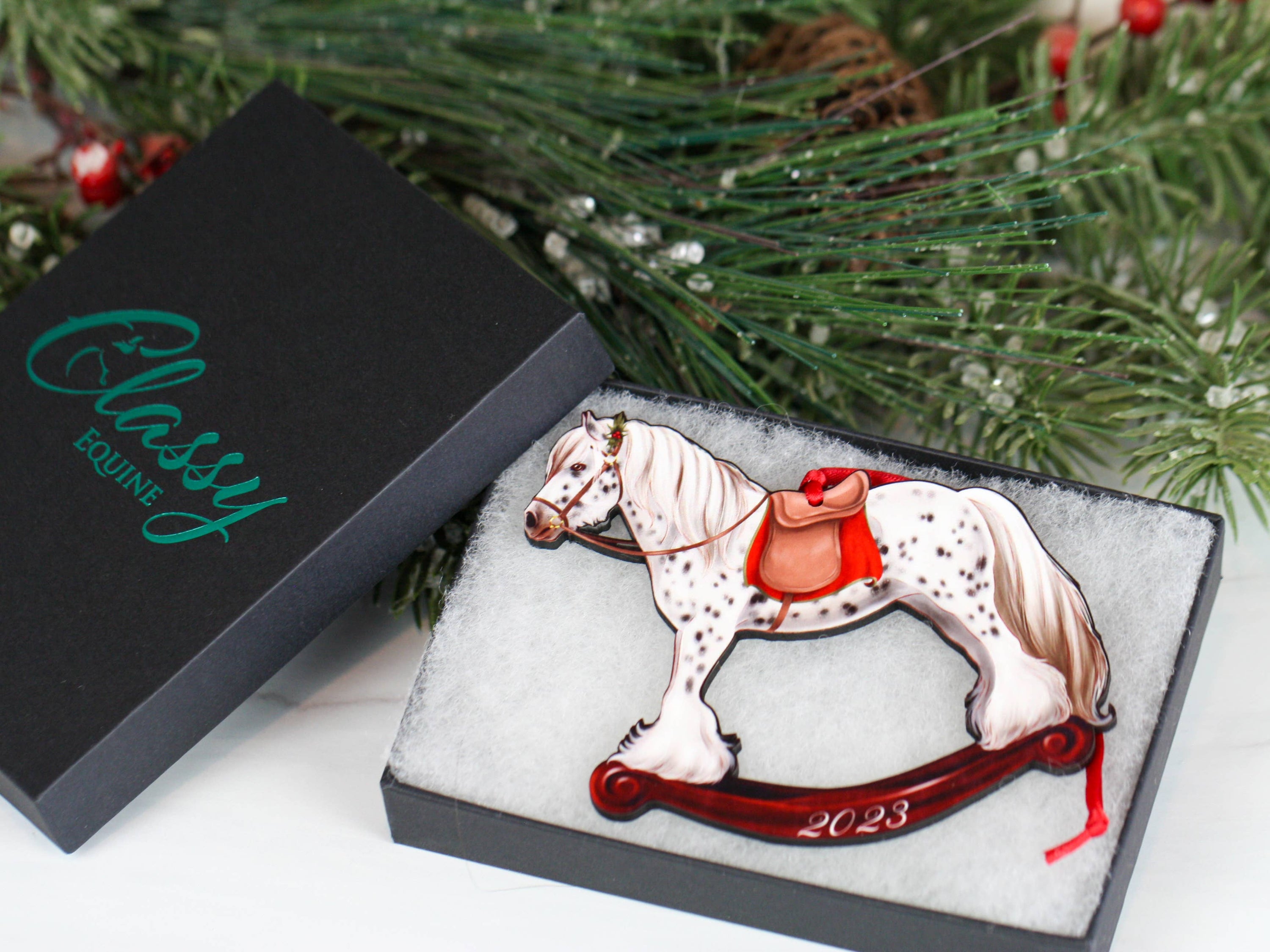 2023 Spotted Gypsy Cob Rocking Horse Christmas Ornament, handmade from composite wood with a glossy finish, featuring red and black ribbons.