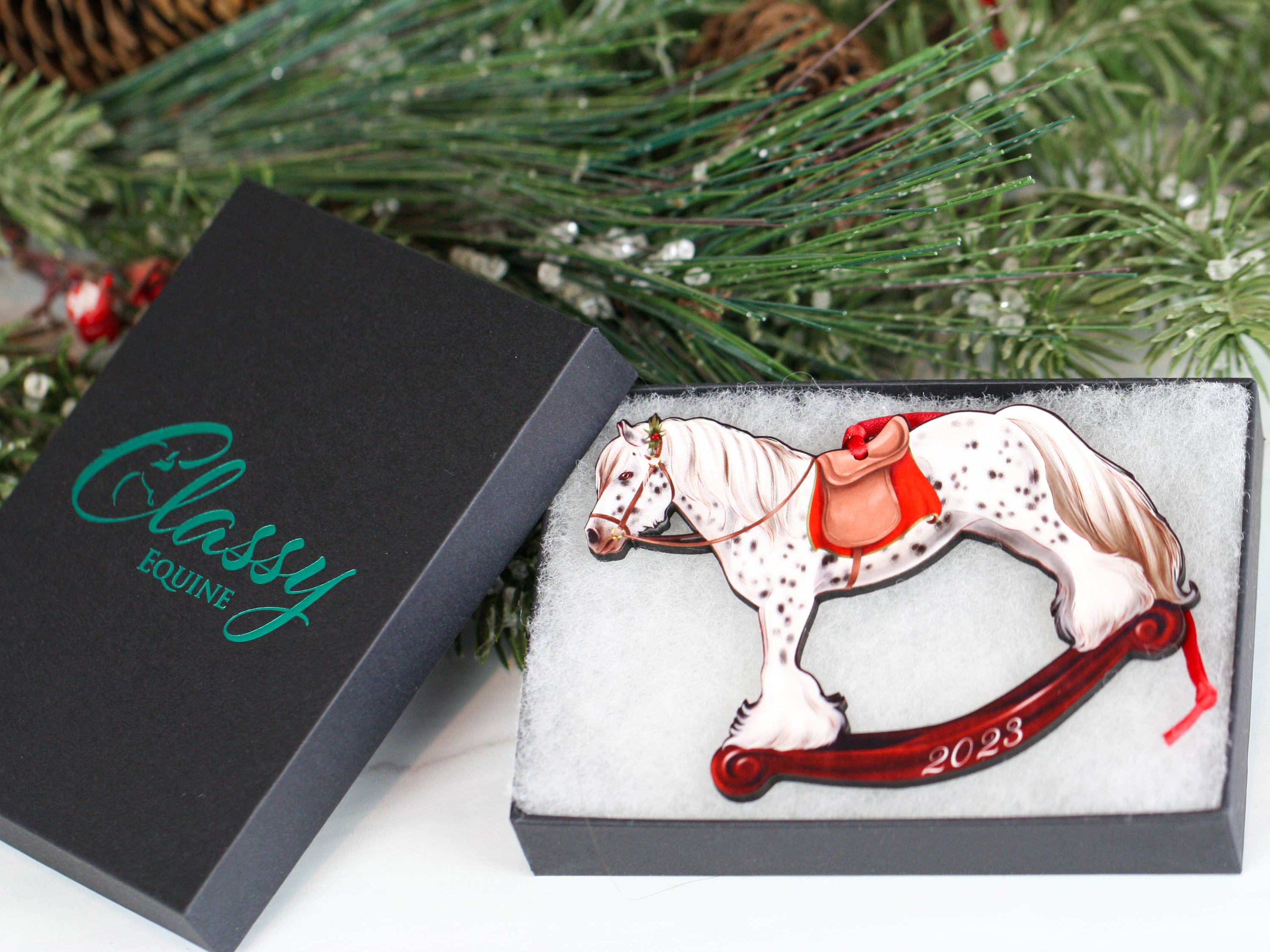 2023 Spotted Gypsy Cob Rocking Horse Christmas Ornament, handmade from composite wood with a glossy finish, featuring red and black ribbons.
