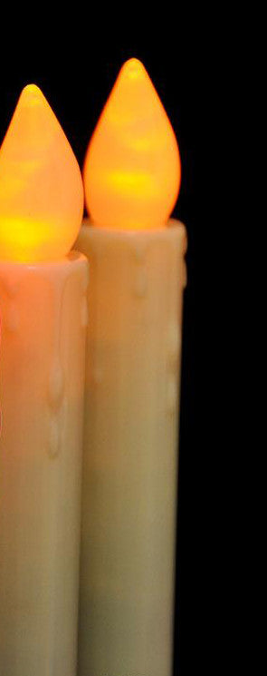 Three elegant white taper stick candles on a gold stand, designed for battery operation with a natural flame light color.