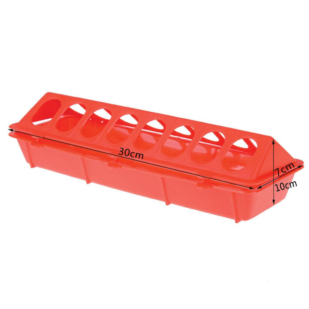 30cm long red plastic poultry feeder with hinged top, designed to minimize feed wastage for chickens and other birds.