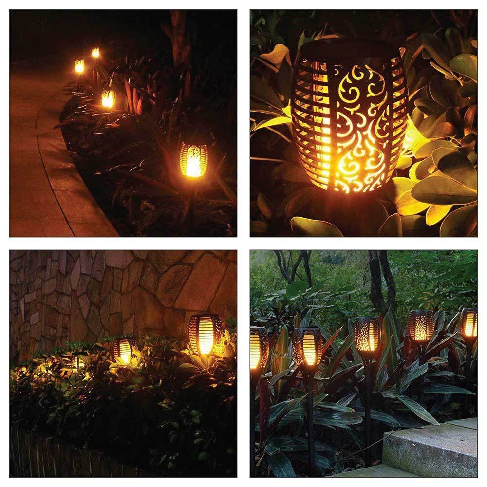 Four solar garden LED torches with flickering flame effect, perfect for outdoor ambiance lighting.