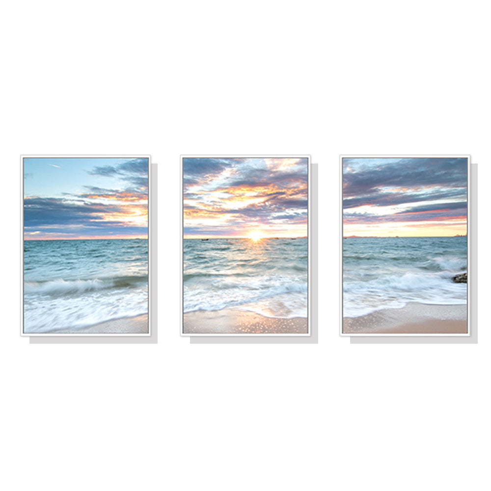 50cmx70cm canvas wall art featuring a vibrant sunrise over the ocean, framed in a stylish white floating frame.