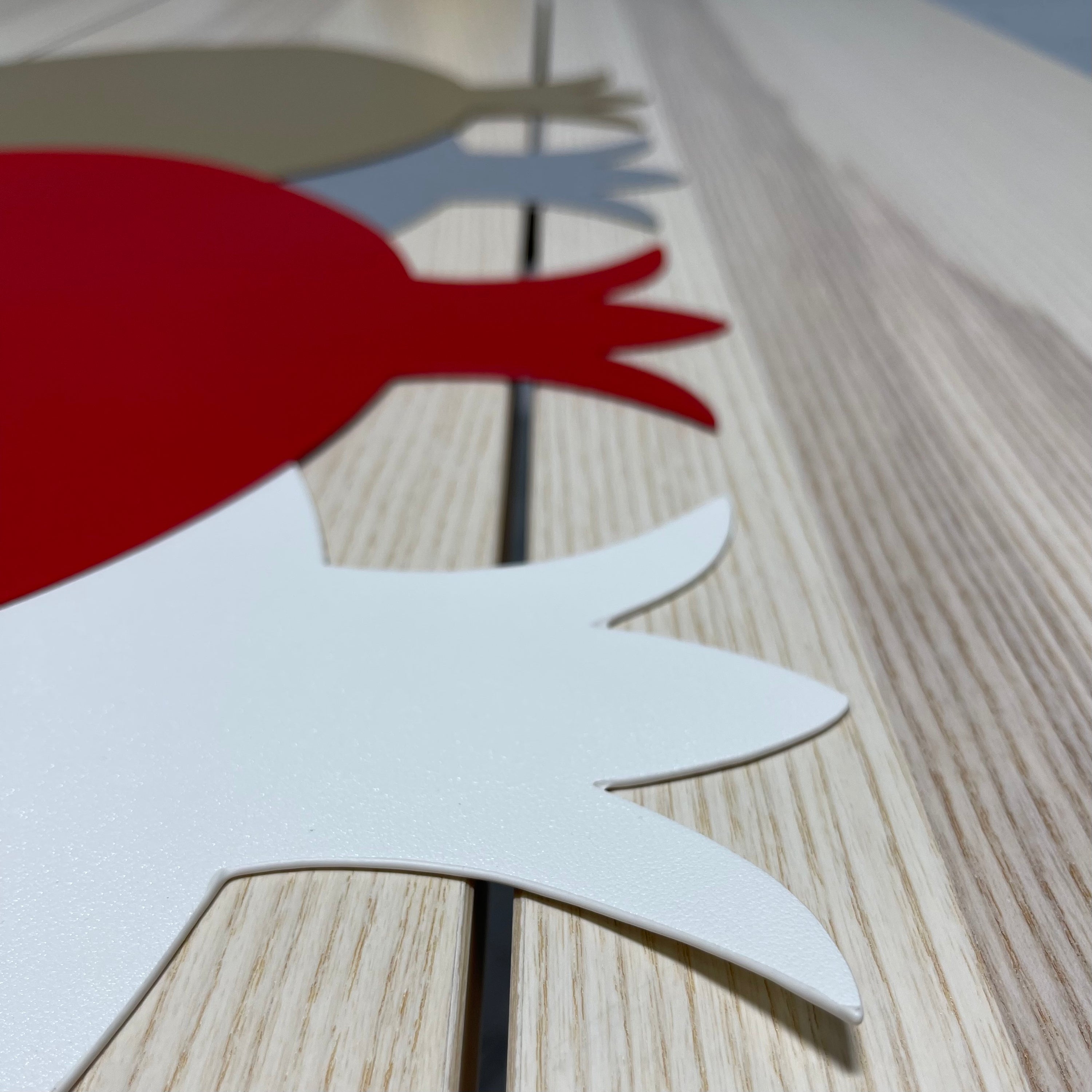 A set of six pomegranate-shaped placemats made from smooth faux leather in vibrant colors, perfect for festive dining.