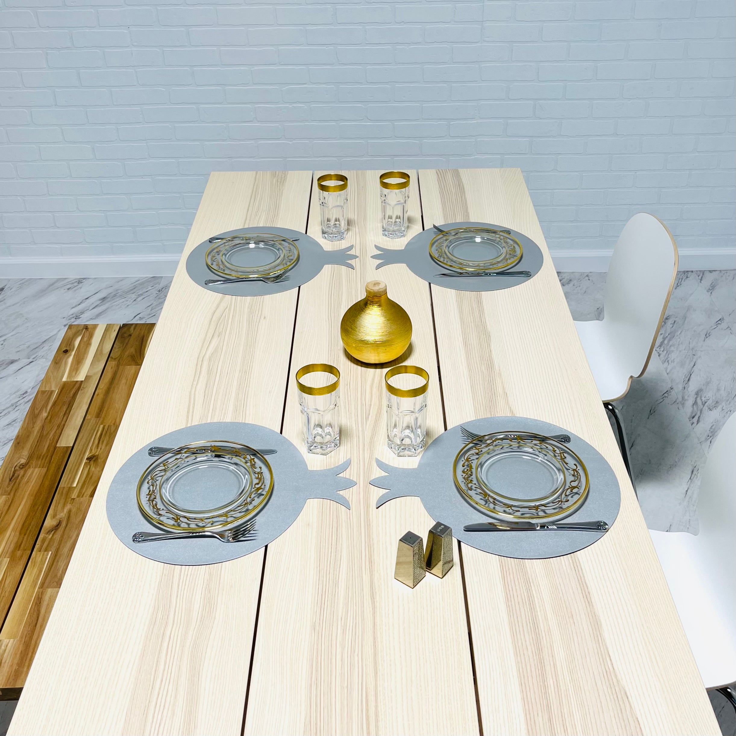 A set of six pomegranate-shaped placemats made from smooth faux leather in vibrant colors, perfect for festive dining.