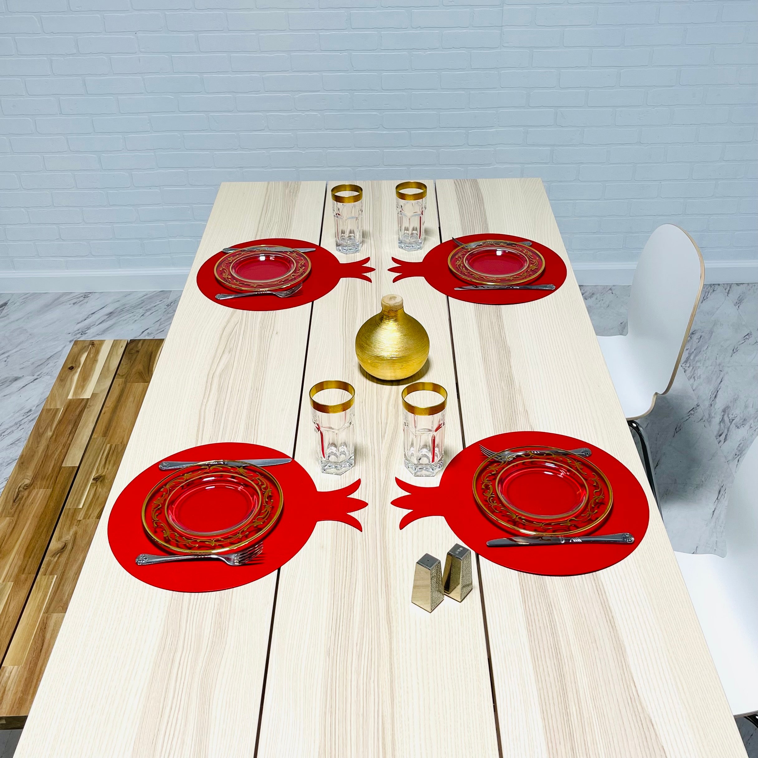 A set of six pomegranate-shaped placemats made from smooth faux leather in vibrant colors, perfect for festive dining.