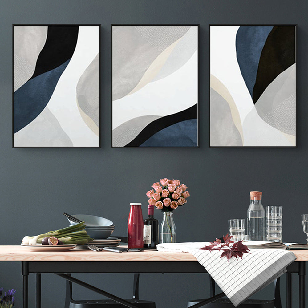 Three-piece abstract navy blue canvas wall art set with black frames, elegantly displayed on a wall.