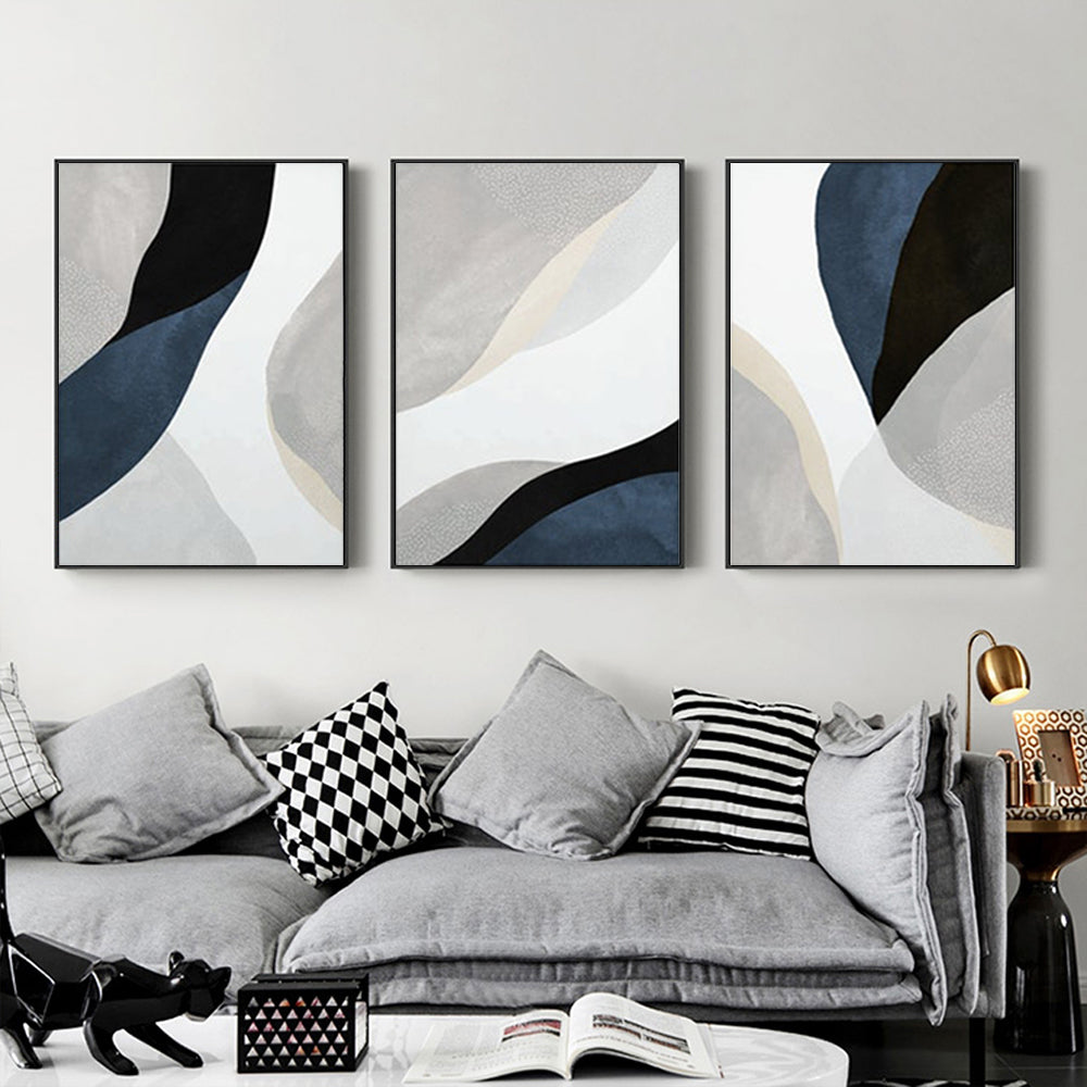 Three-piece abstract navy blue canvas wall art set with black frames, elegantly displayed on a wall.