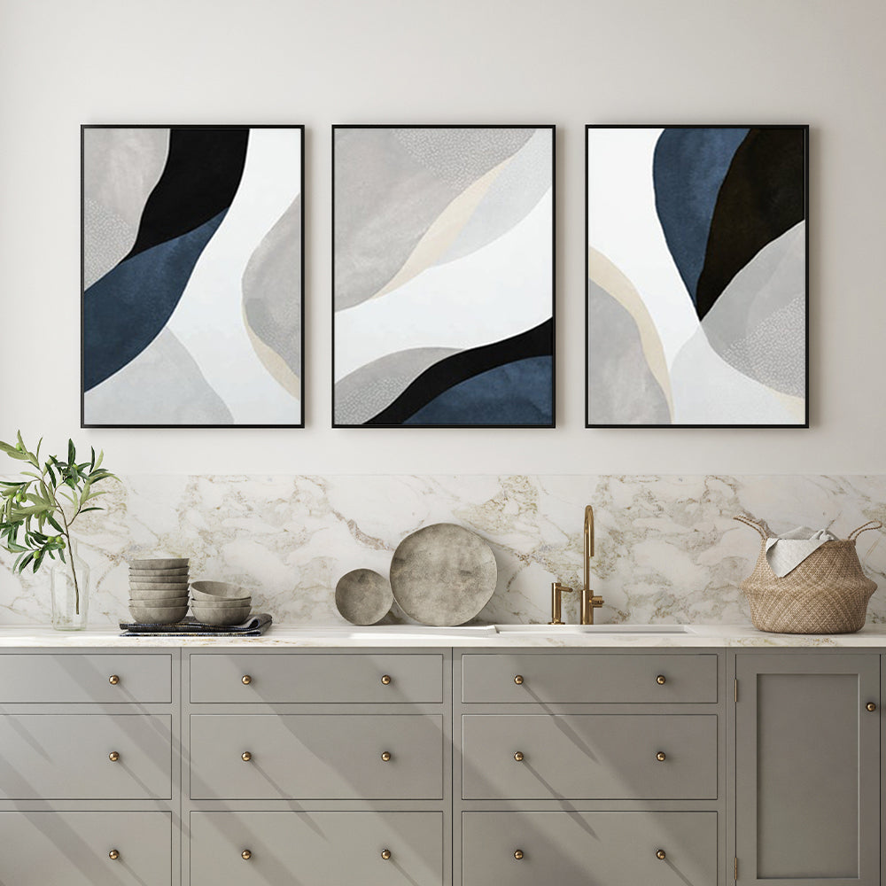 Three-piece abstract navy blue canvas wall art set with black frames, elegantly displayed on a wall.