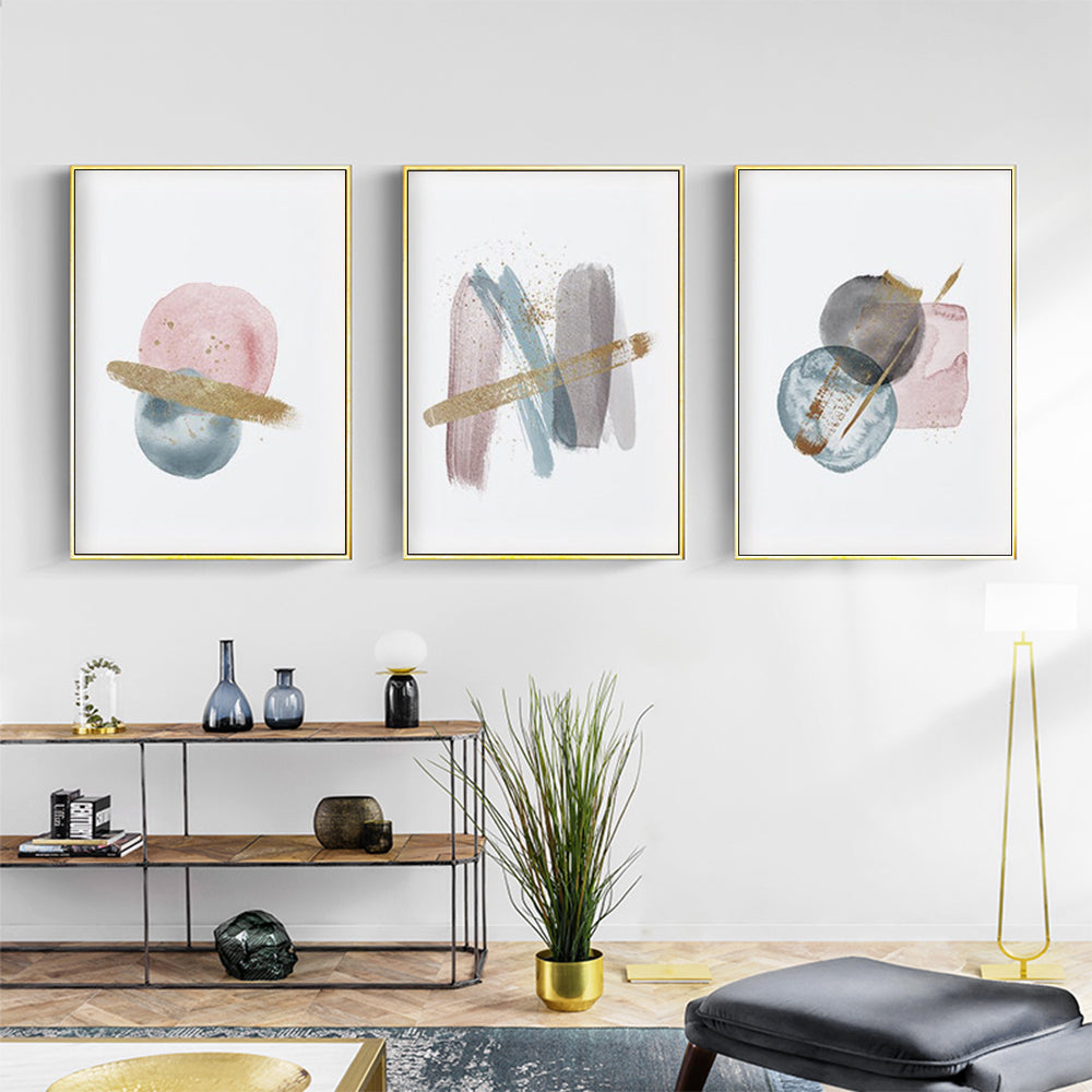 A beautifully framed blush pink watercolor canvas wall art set in gold frames, showcasing elegant designs perfect for home decor.
