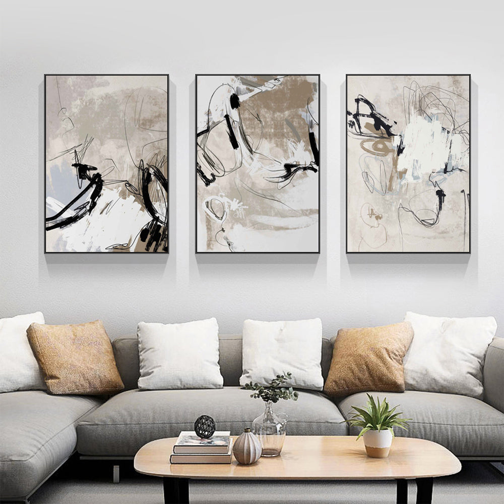 Three-piece modern abstract beige canvas wall art set in black frames, showcasing elegant design and premium quality.