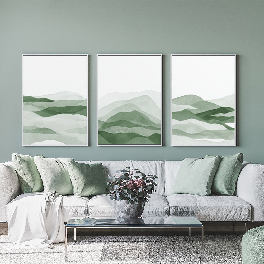 Three sets of sage green canvas wall art framed in white, showcasing modern design and vibrant colors.