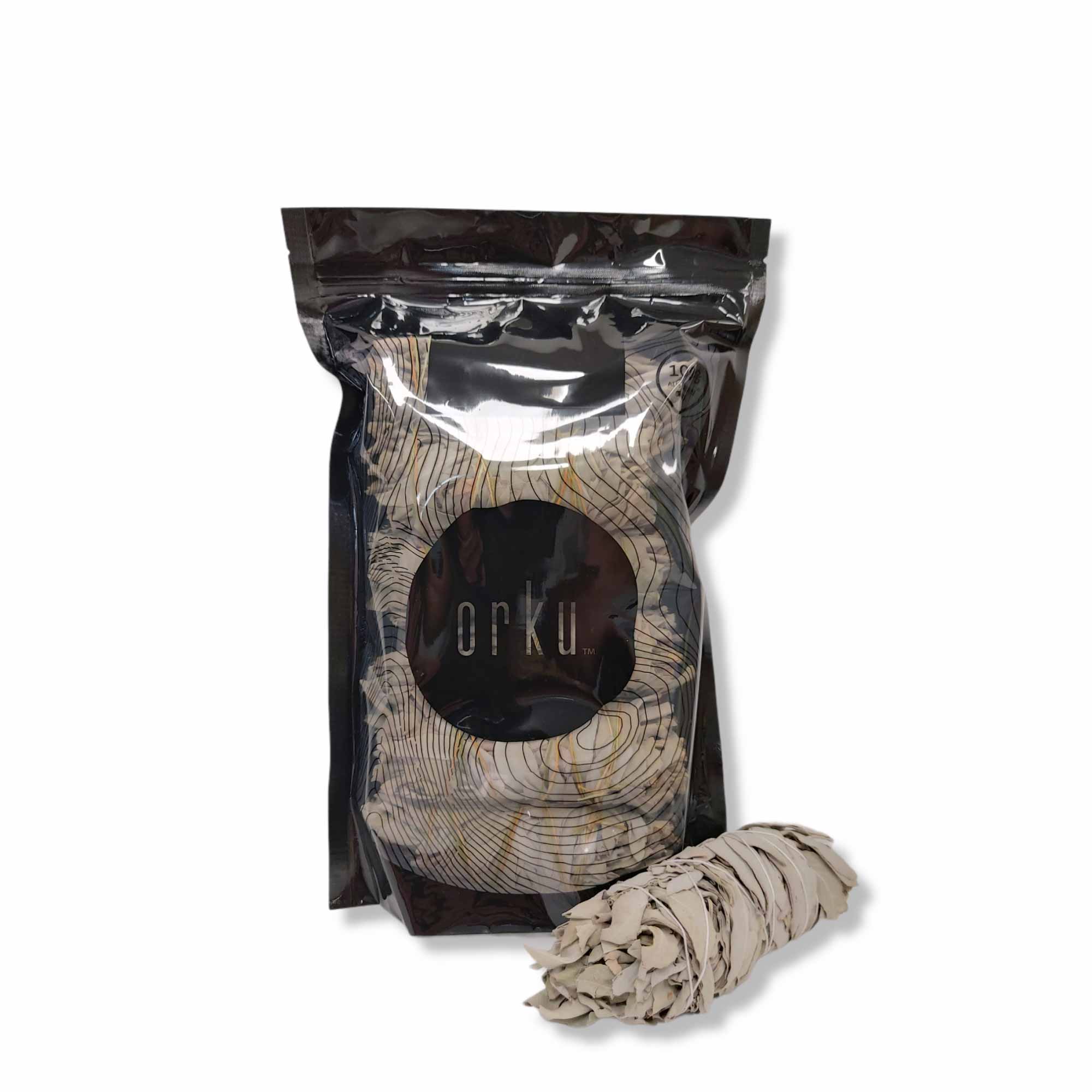 A bundle of 6 medium Californian white sage smudge sticks, hand-rolled and wrapped in cotton string, showcasing their natural green leaves.