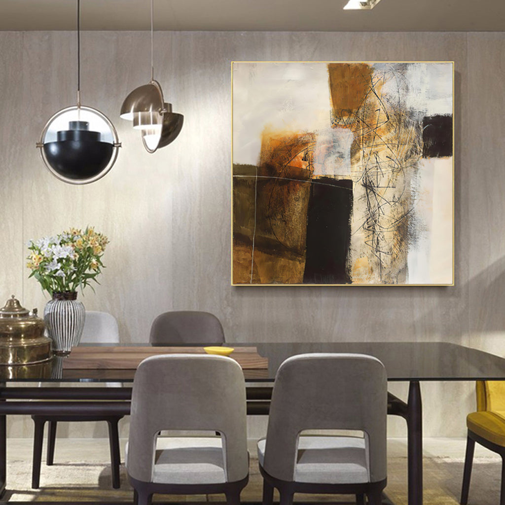 A 70cmx70cm abstract painting featuring gold and brown tones, elegantly framed in a luxurious gold frame, ready to enhance any wall.