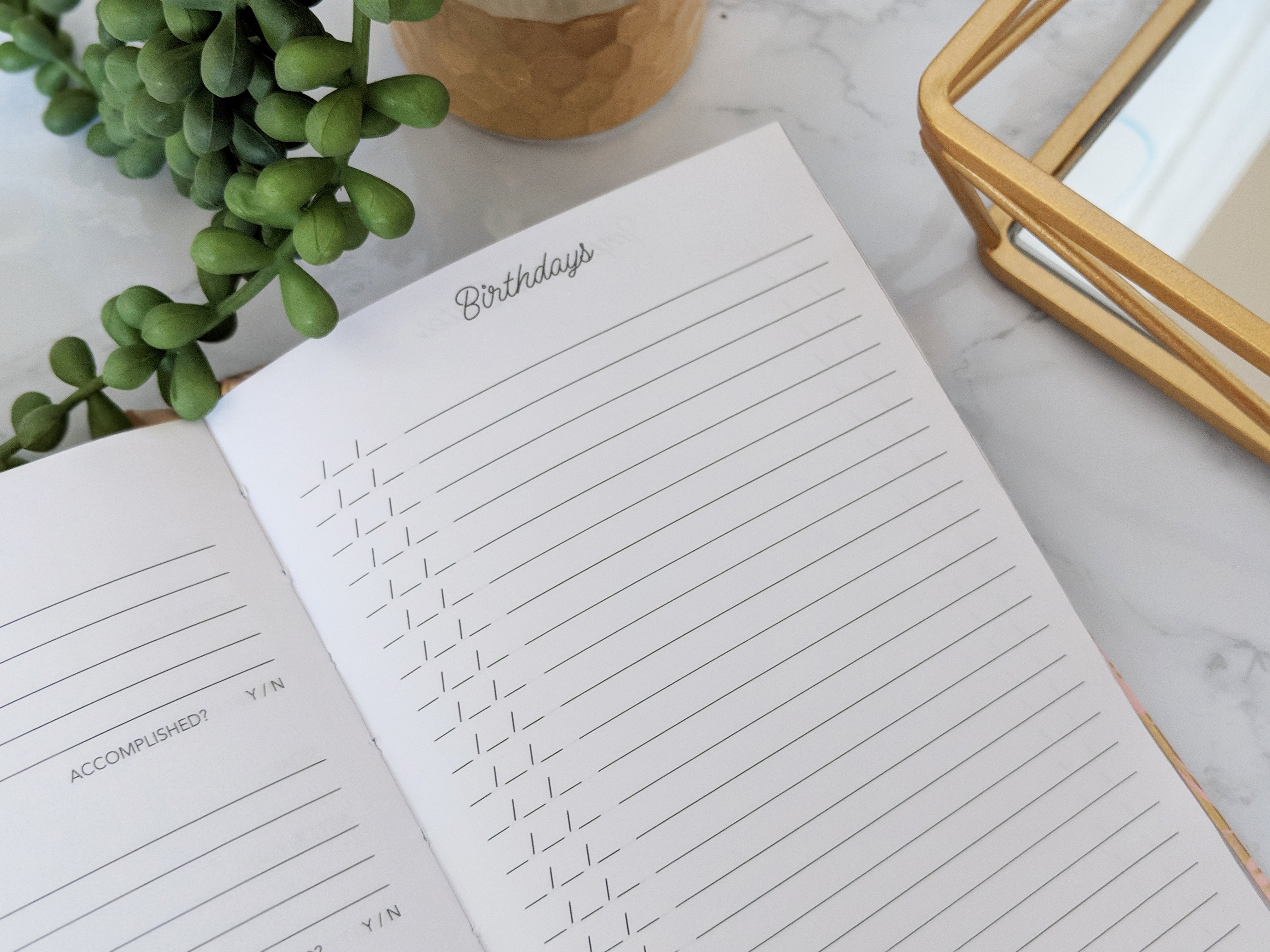 A beautiful navy floral five-year journal with gold accents, featuring a bookmark ribbon and gold foil edges, perfect for daily reflections.