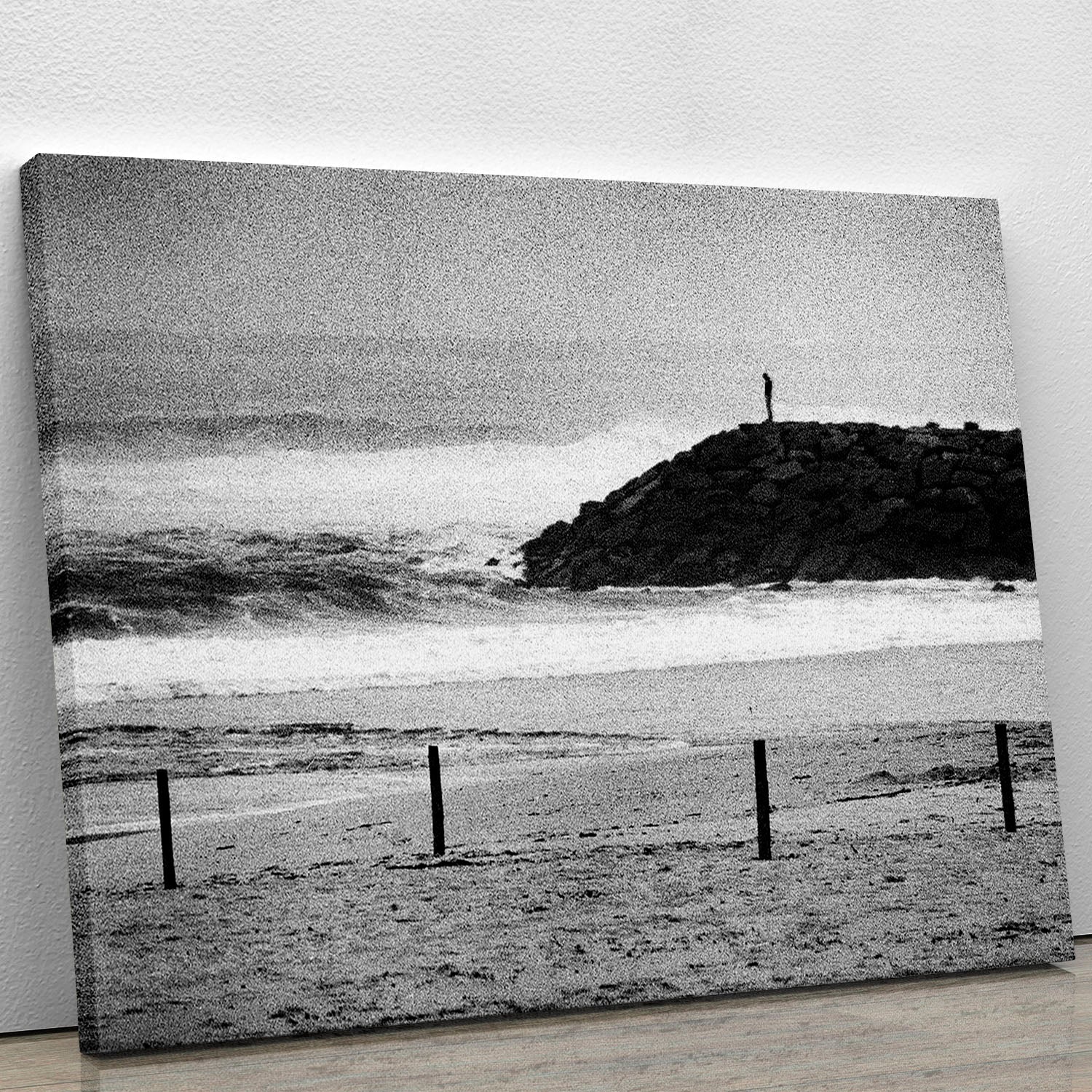 A beautiful canvas print featuring a lone figure standing on cliffs overlooking a serene landscape, perfect for home decor.