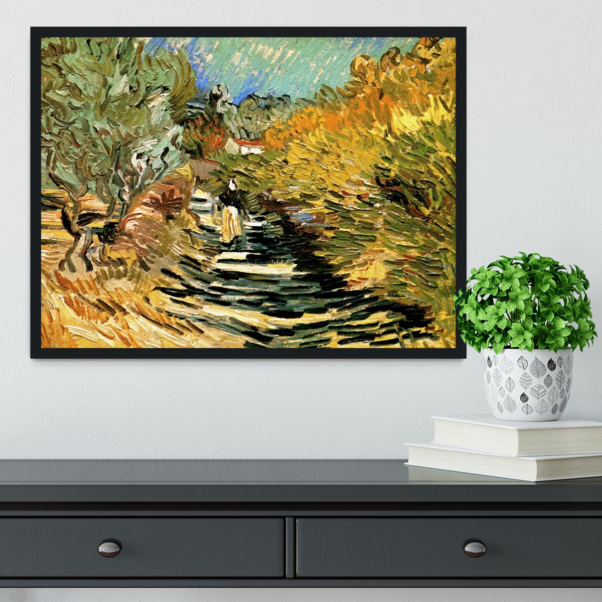 Framed print of Van Gogh's 'A Road at Saint-Remy with Female Figure', showcasing vibrant colors and intricate details.