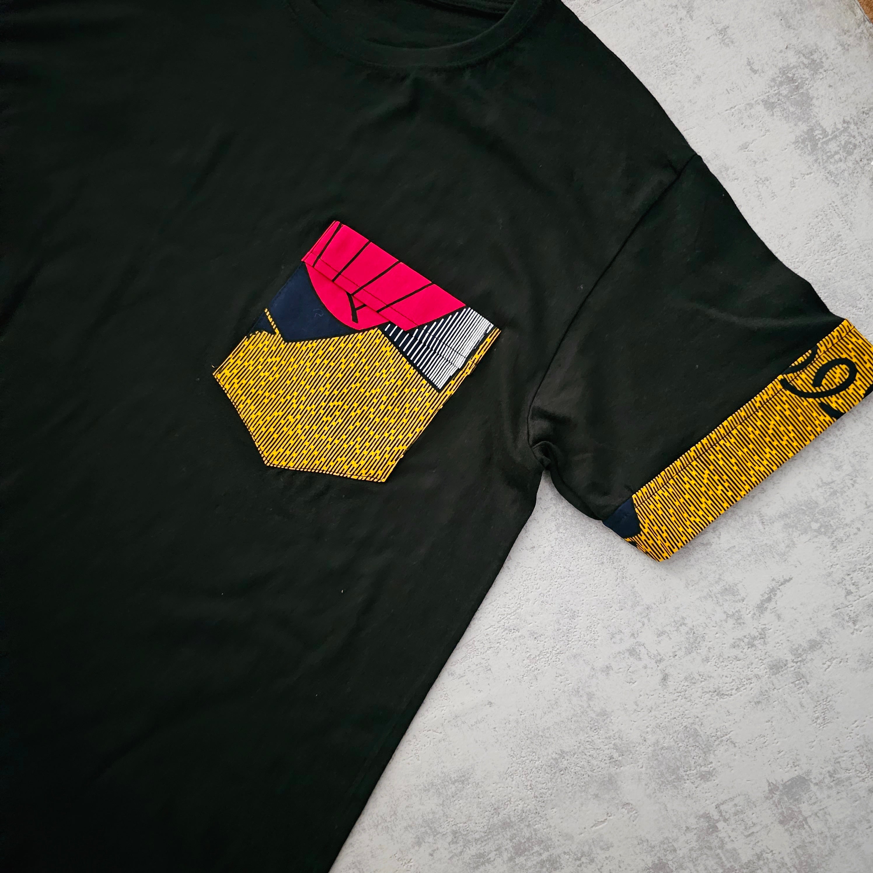 Black unisex t-shirt featuring unique Bogolan print detail and pocket, made from 100% soft cotton jersey.