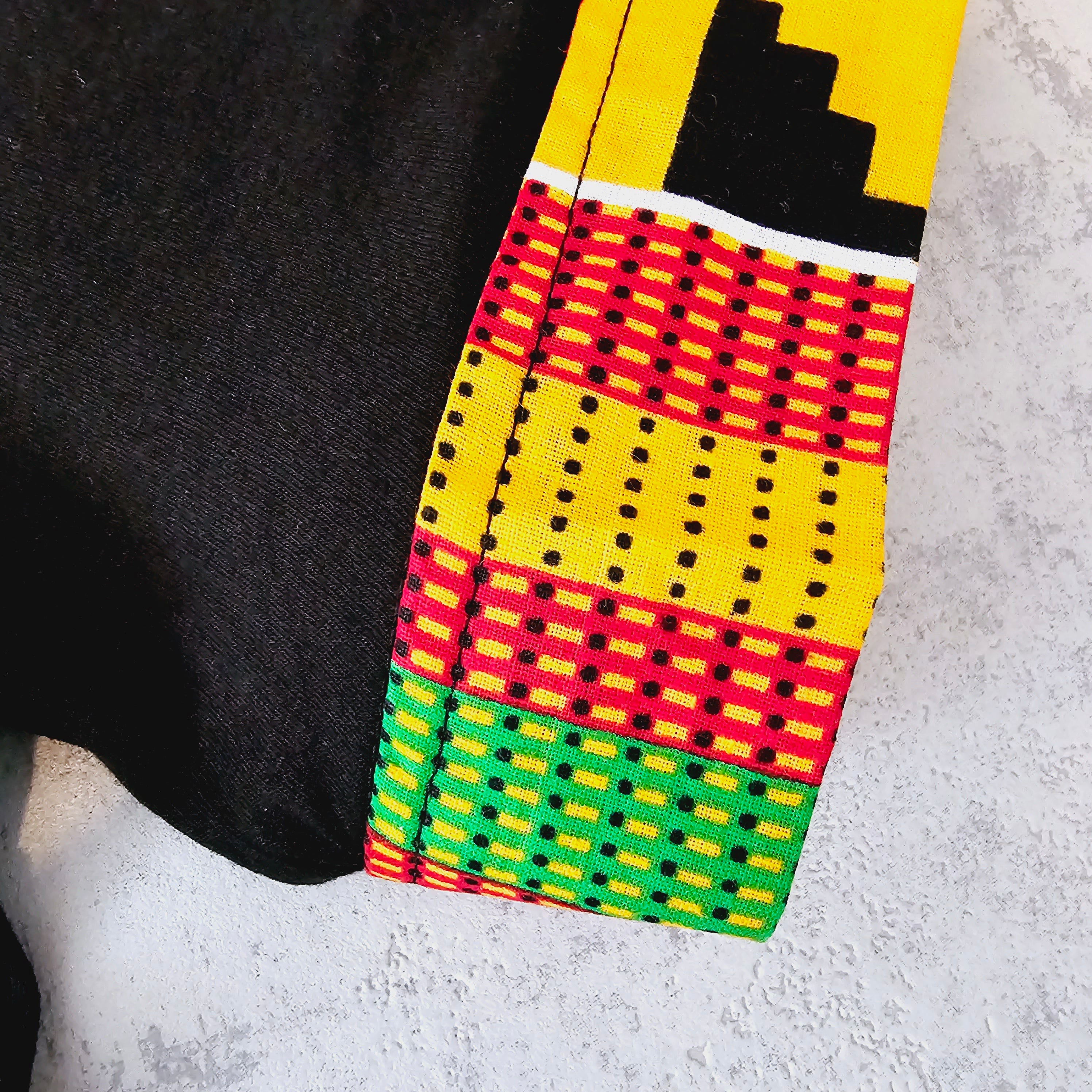 Africa Print Detailed T-Shirt featuring a black base with vibrant African print details and a pocket, showcasing a casual yet stylish design.