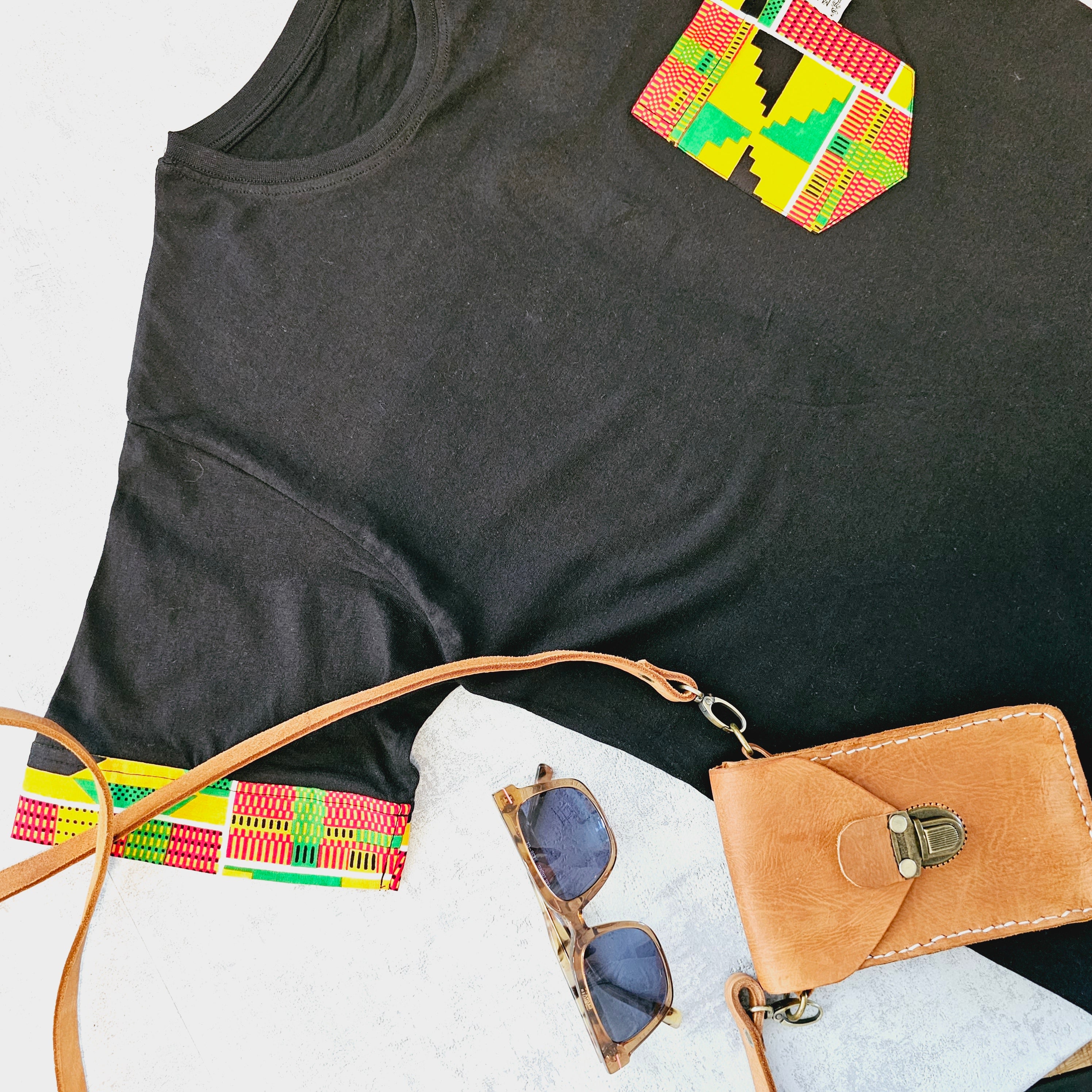 Africa Print Detailed T-Shirt featuring a black base with vibrant African print details and a pocket, showcasing a casual yet stylish design.