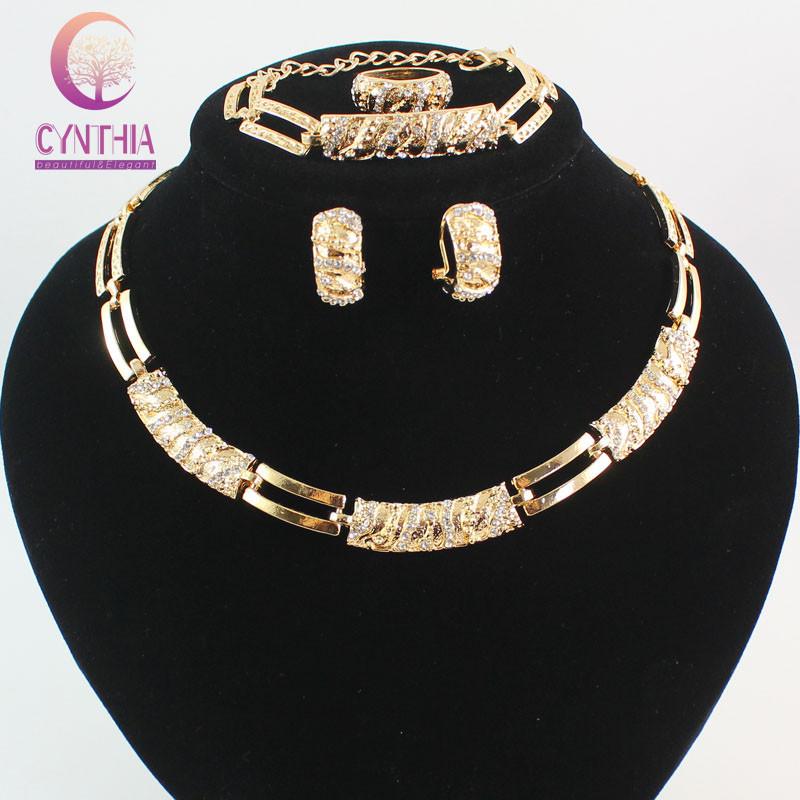 Elegant African Beads Jewelry Set featuring 18K gold plating and sparkling crystals, including a bracelet, earrings, and necklace.