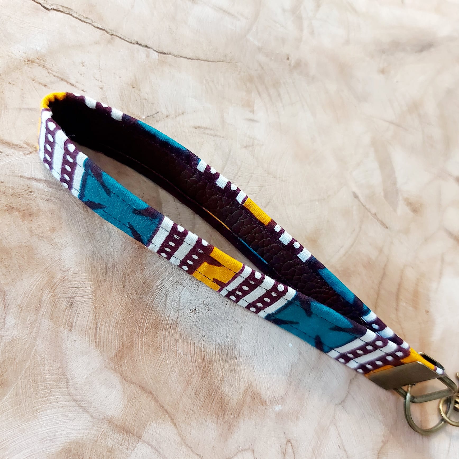 African Print and Leather Key Fob wristlet, showcasing vibrant fabric and sturdy vegan leather lining.
