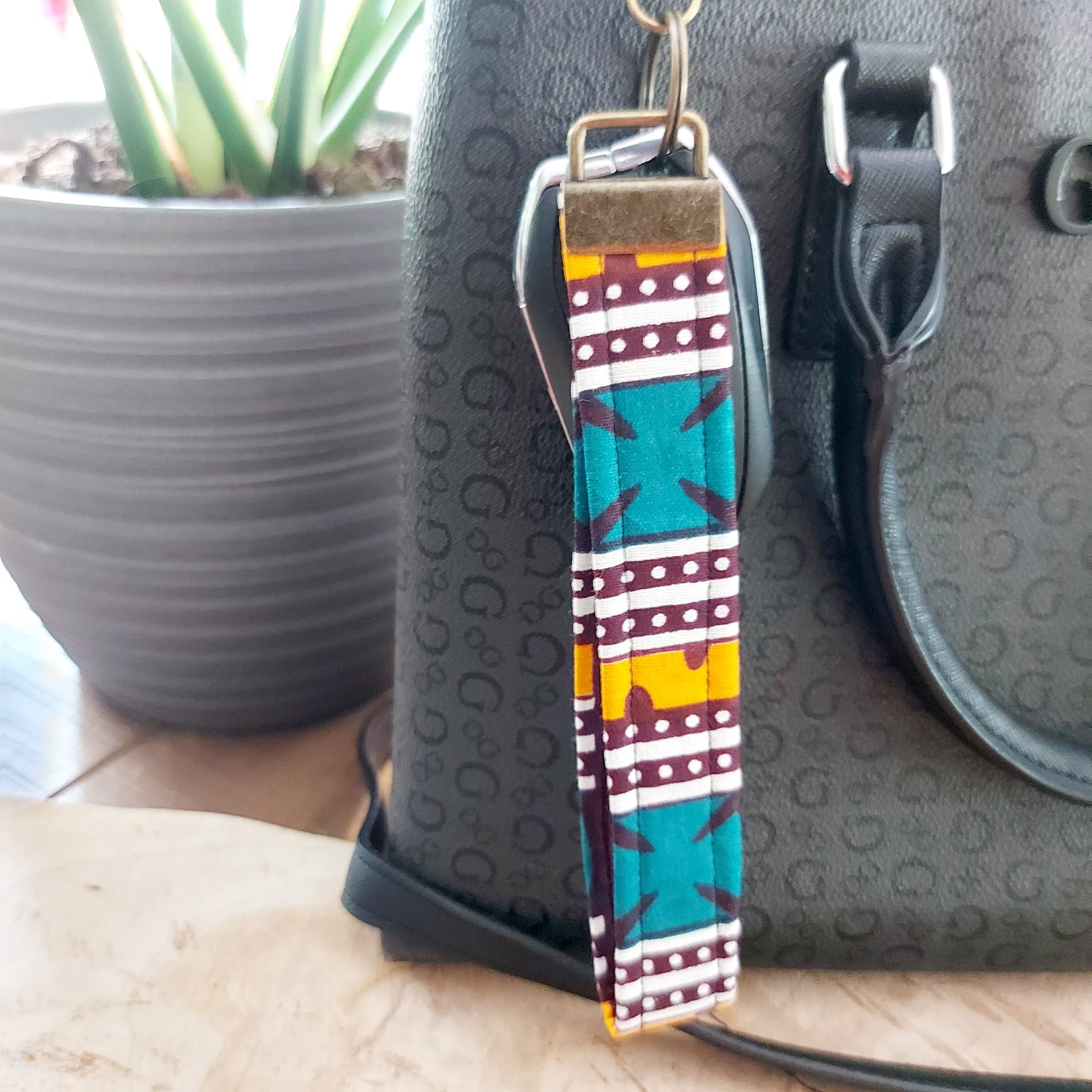 African Print and Leather Key Fob wristlet, showcasing vibrant fabric and sturdy vegan leather lining.