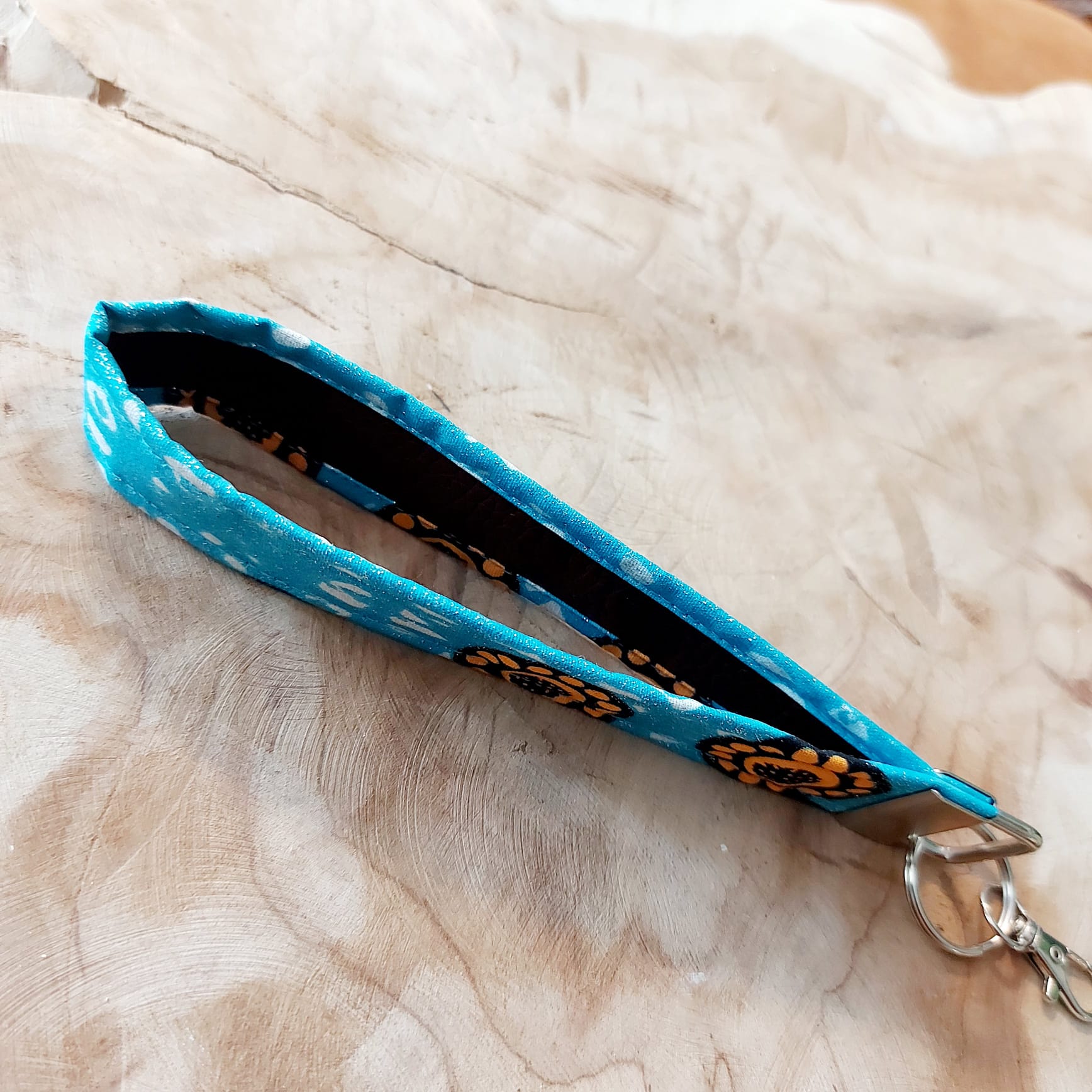 African Print and Leather Key Fob wristlet, showcasing vibrant fabric and sturdy vegan leather lining.